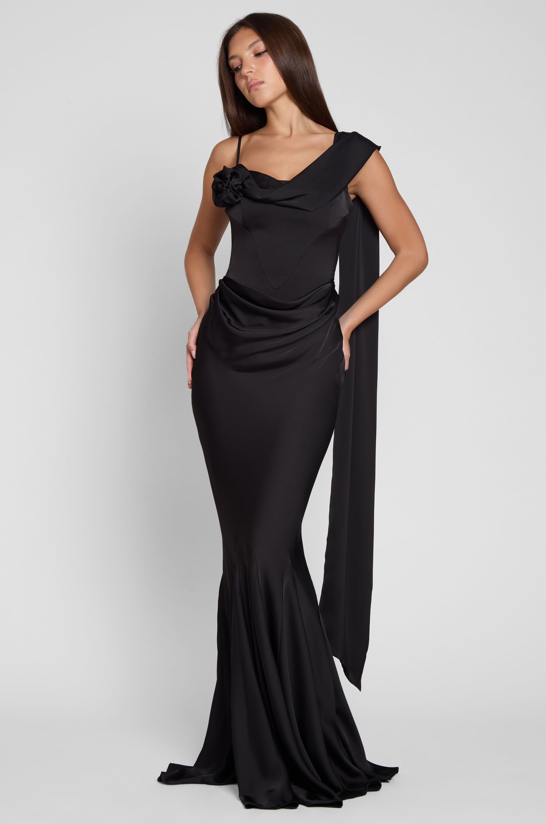 Model is wearing Celine Corset Drape Satin Gown in Black, front view.