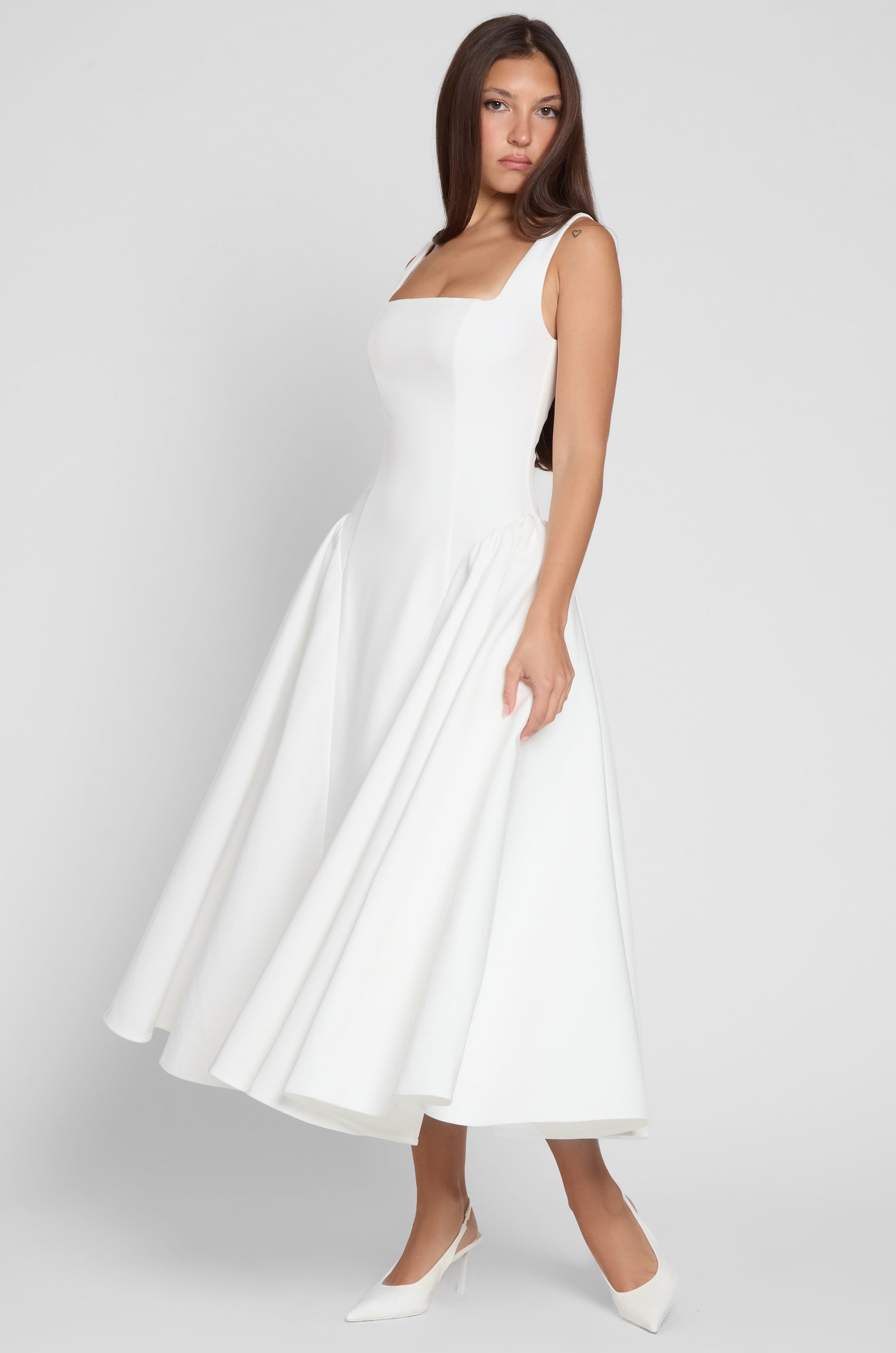 Model is wearing Chloe Corset Midi Dress White, front view.