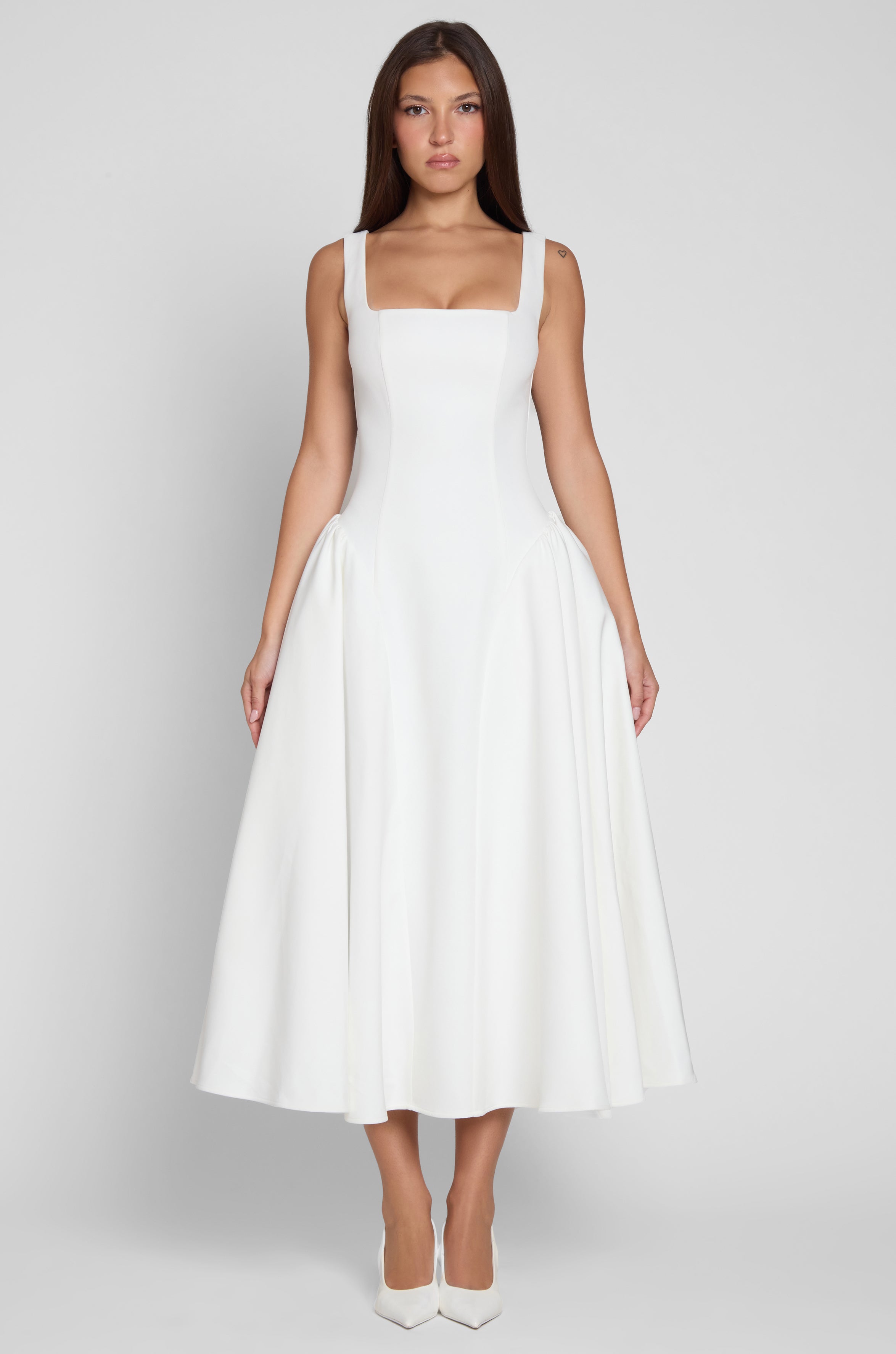 Model is wearing Chloe Corset Midi Dress White, front view.