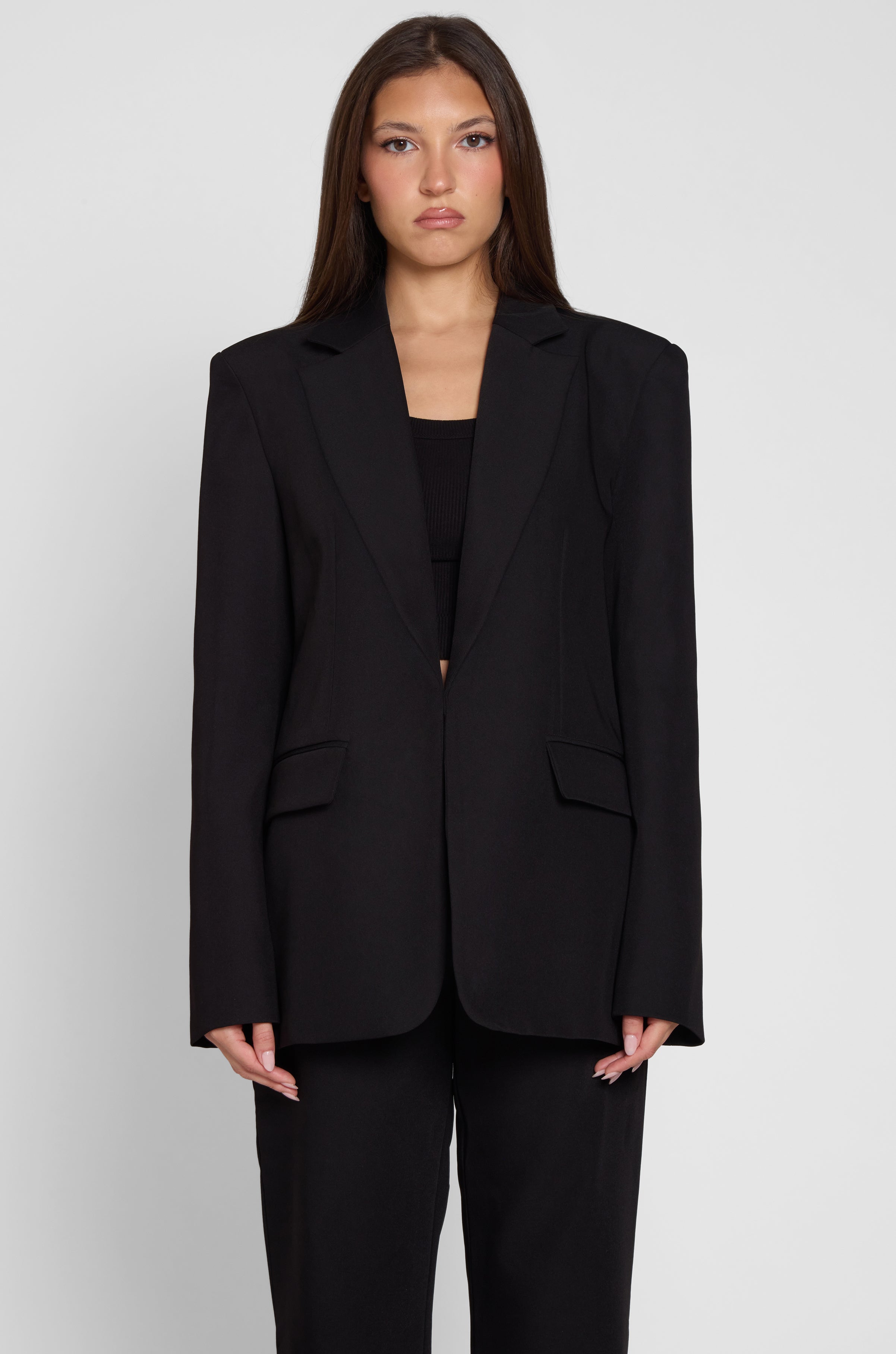 Model is wearing Classic Column Oversized Blazer in Black, front view.