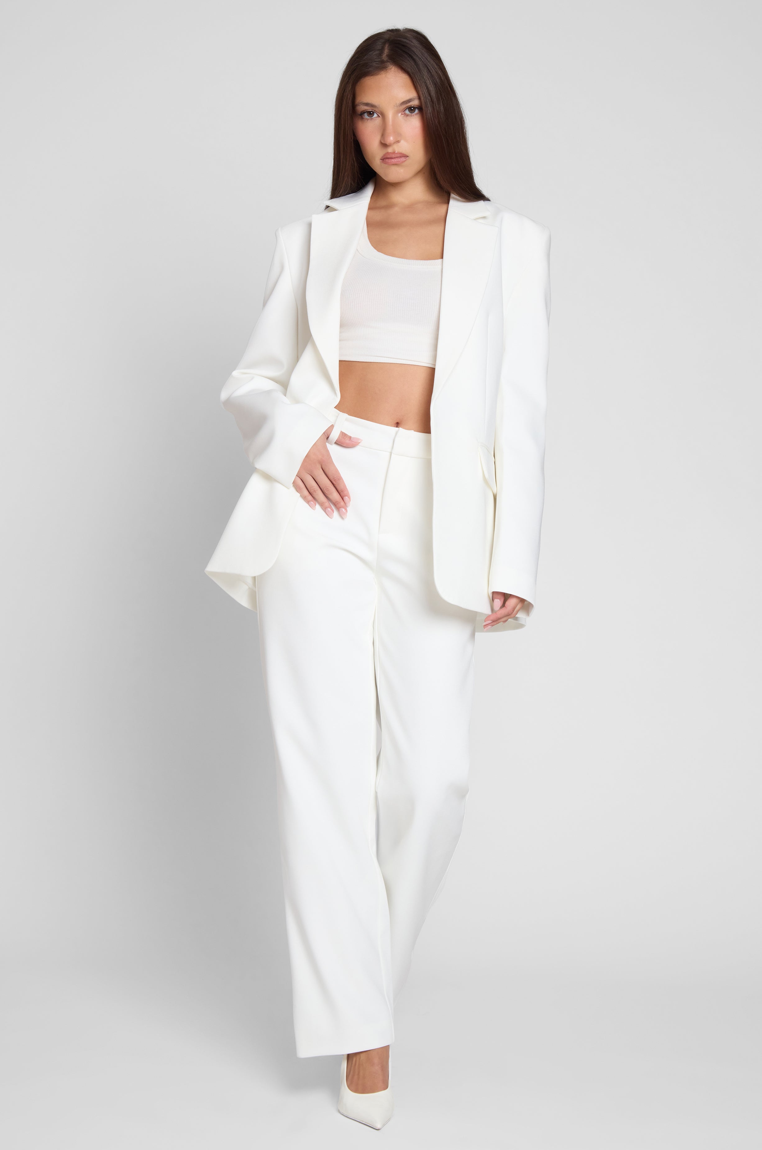 Model is wearing Classic Column Oversized Blazer in White, front view.