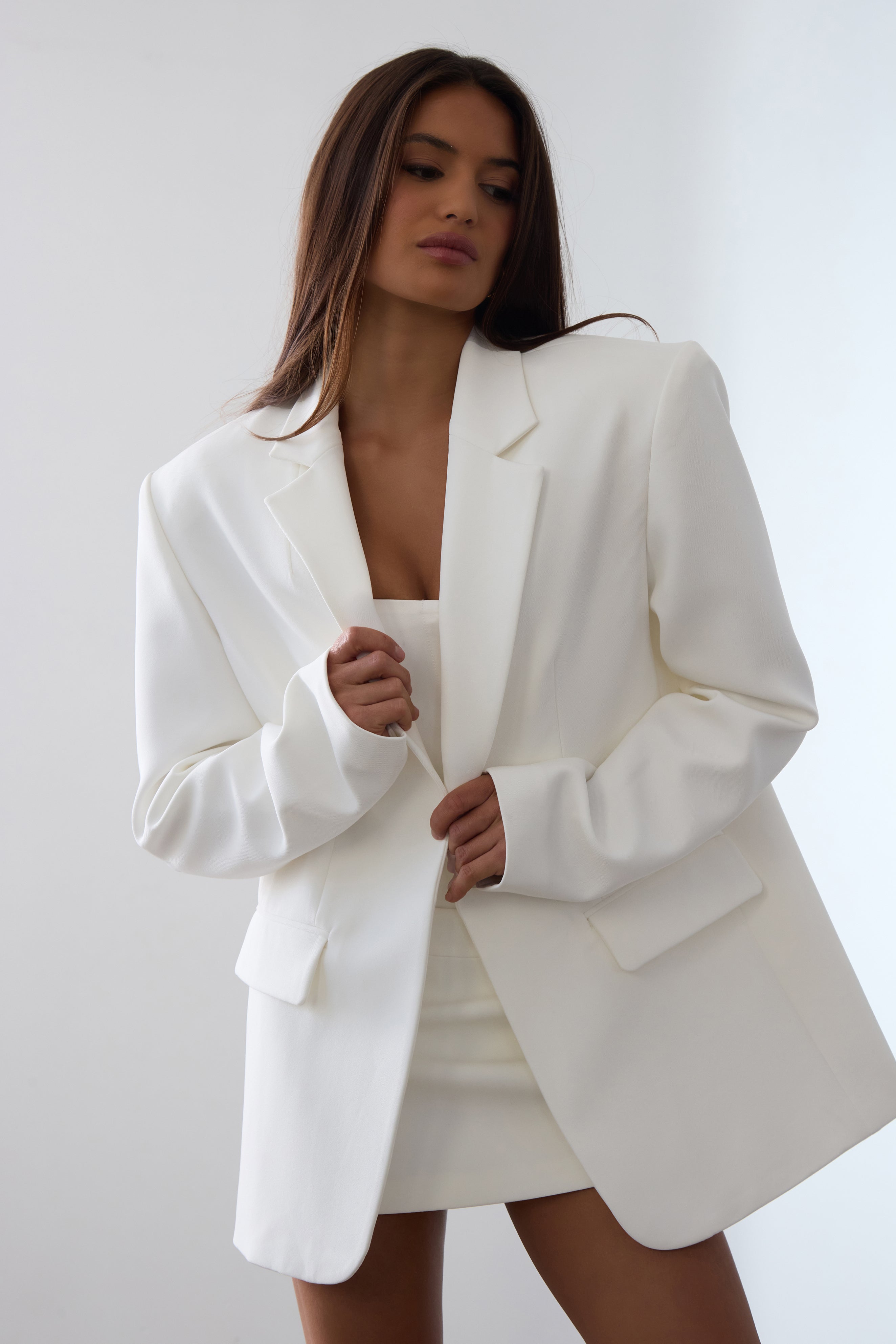 Model is wearing Classic Column Oversized Blazer in White, front view.