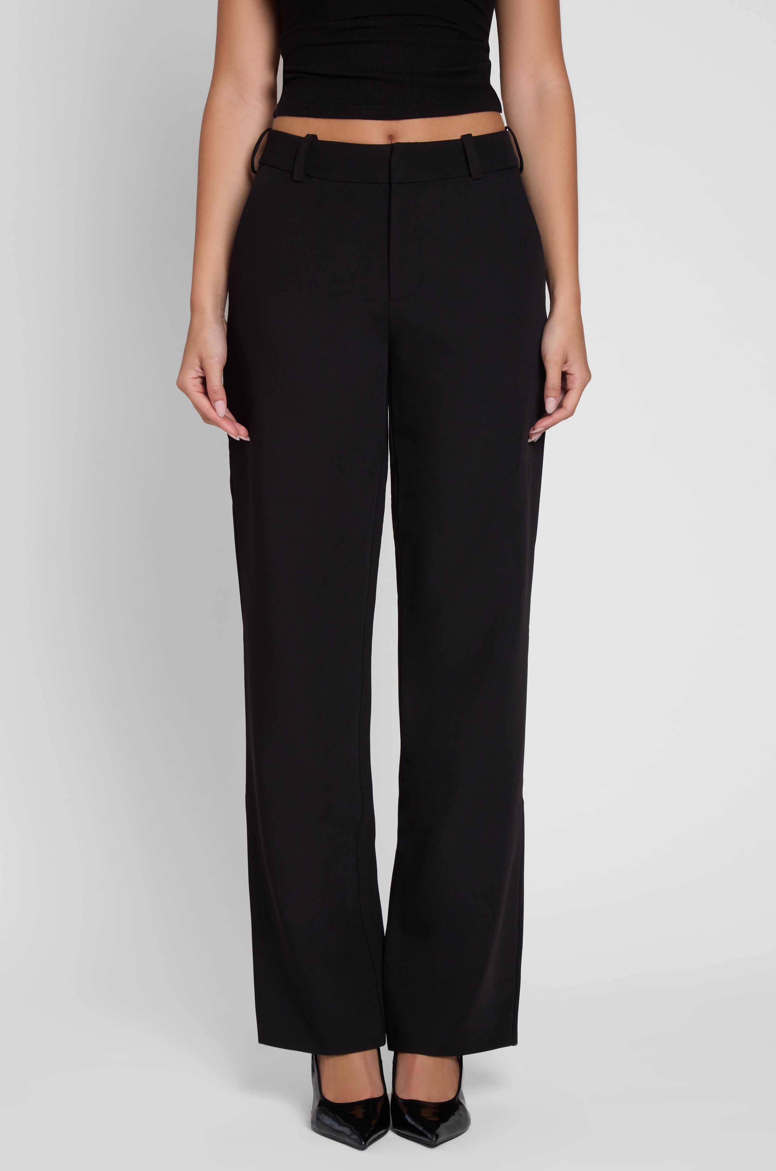 Model is wearing Classic Column Straight Trousers in Black, front view.