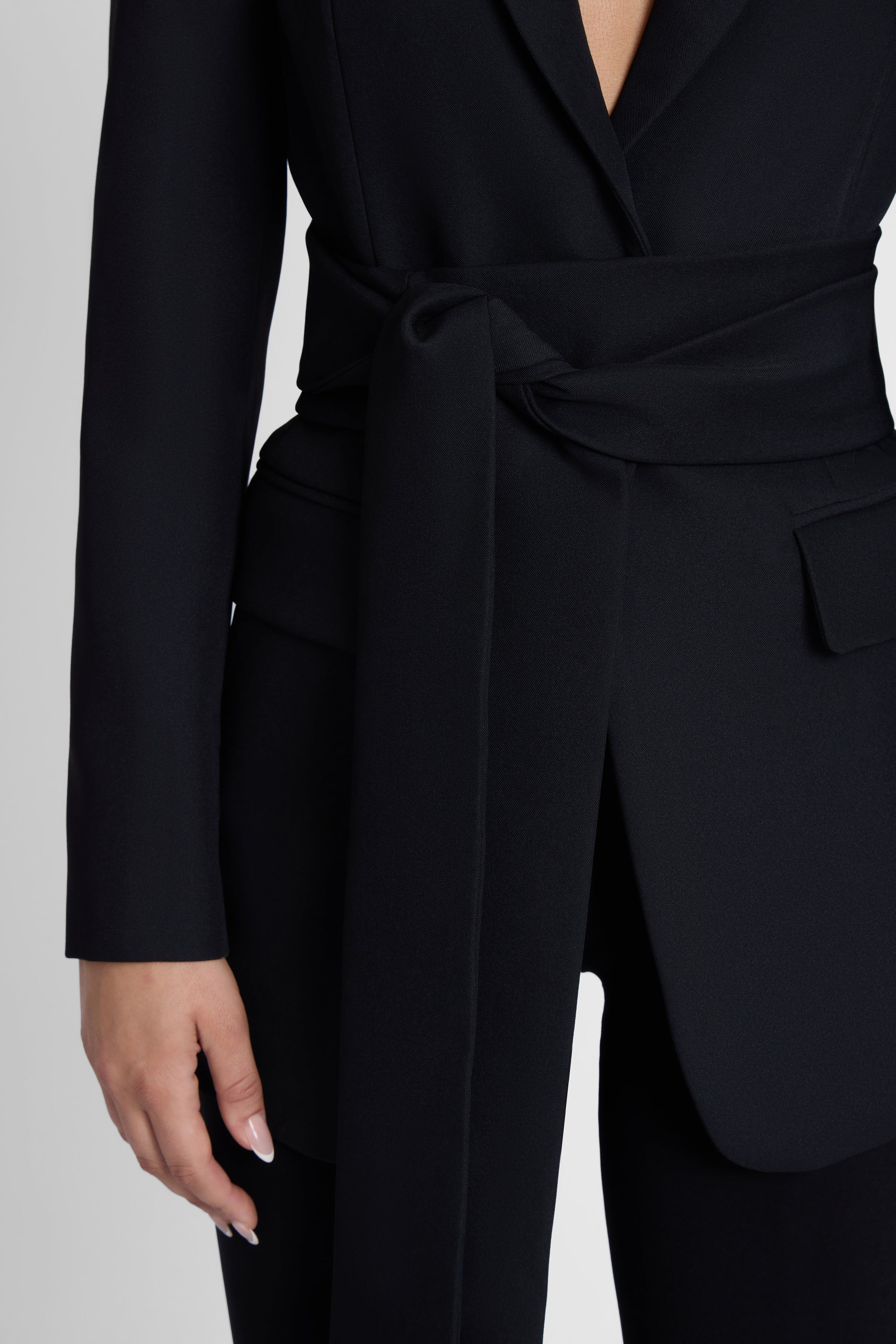 Model is wearing Classic Column Tailored Belted Blazer Black, front view.