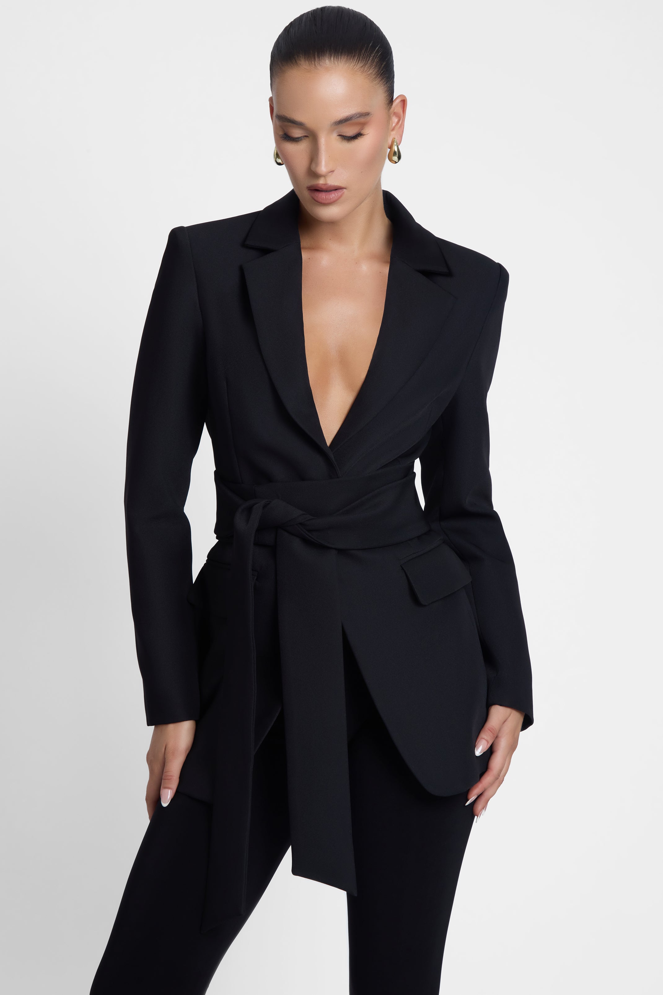 Model is wearing Classic Column Tailored Belted Blazer Black, front view.