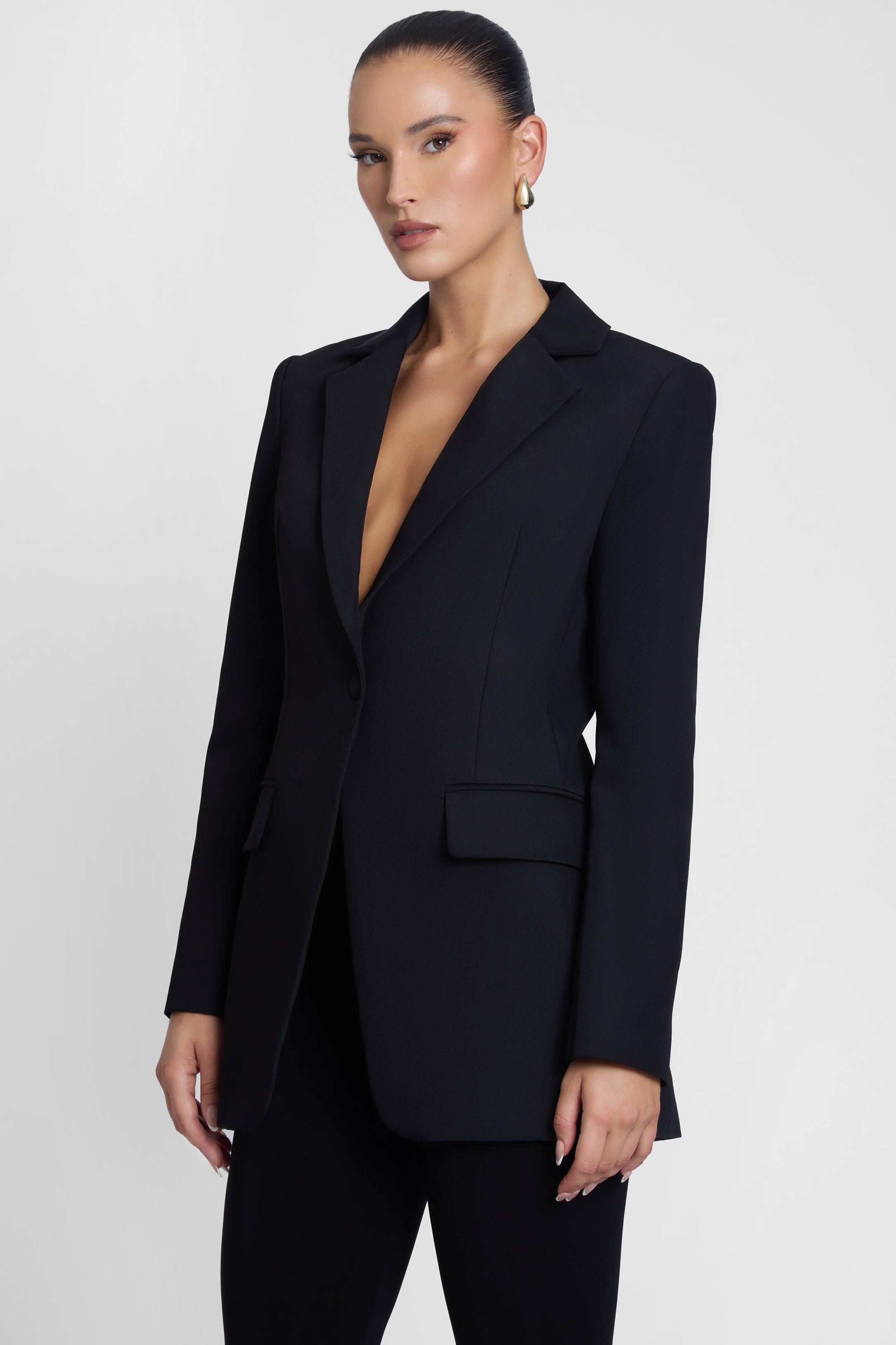 Model is wearing Classic Column Tailored Belted Blazer Black, side view.