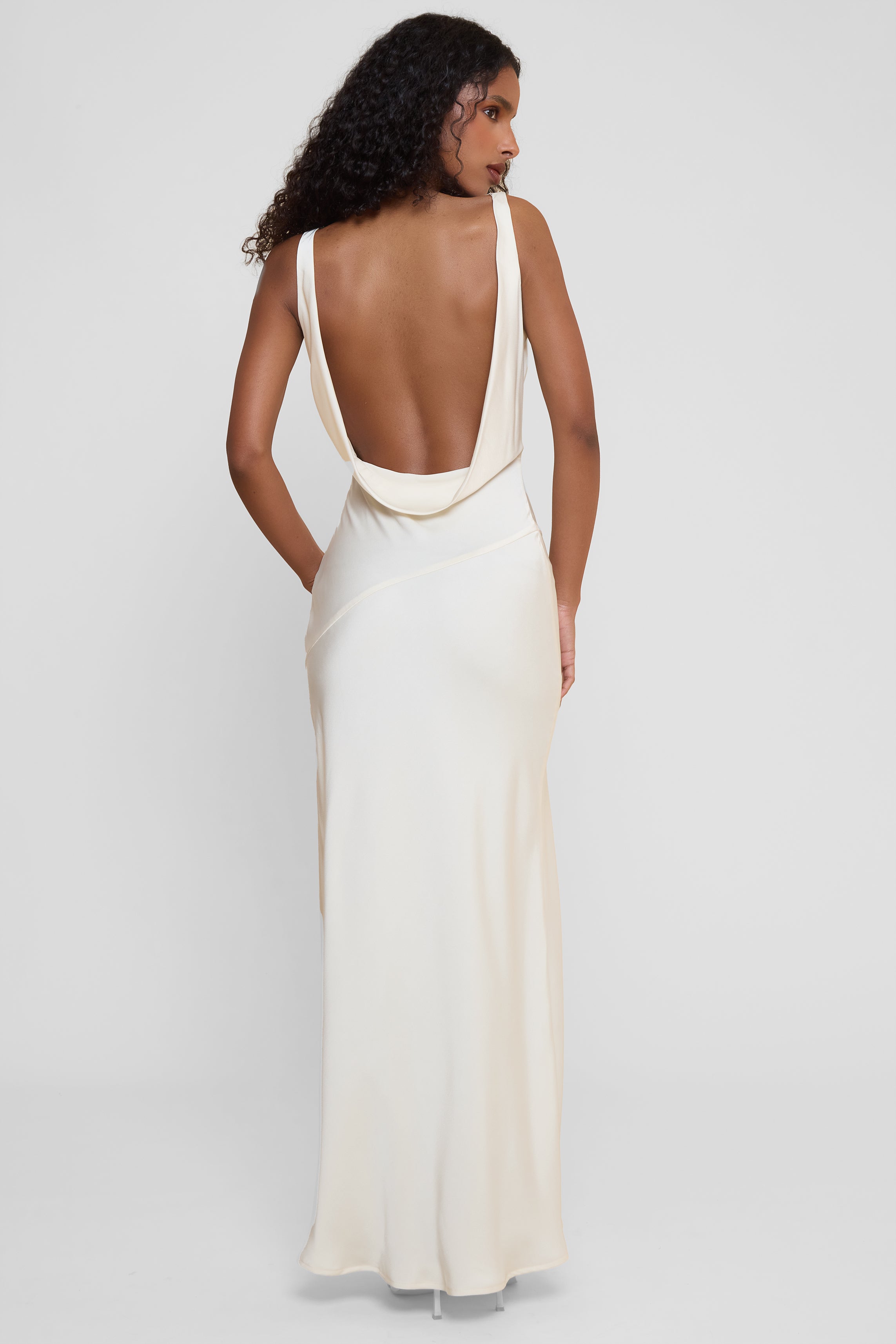 Model wearing Dove Drape Satin Gown in Ivory, back view.