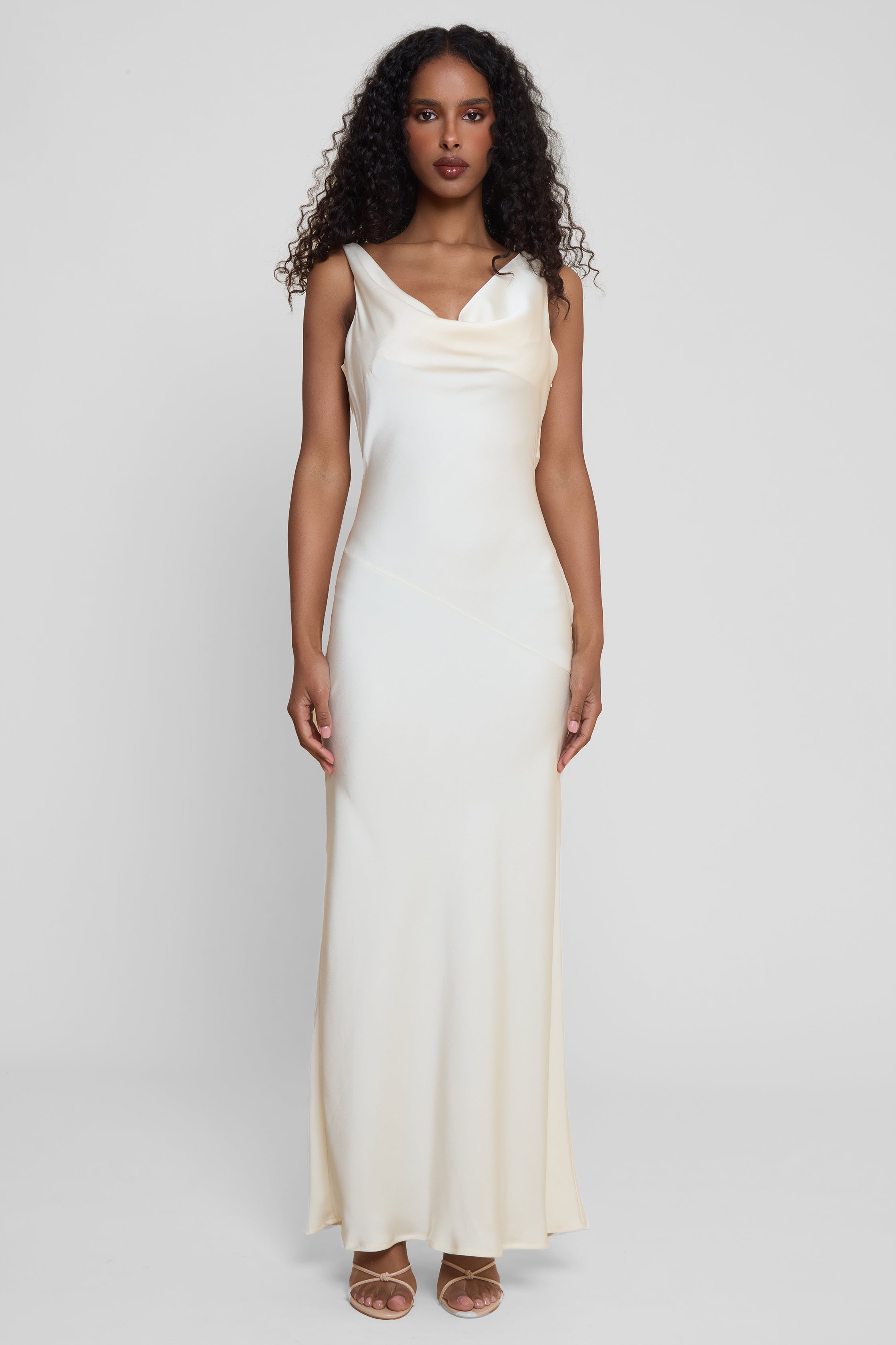 Model wearing Dove Drape Satin Gown in Ivory, front view.