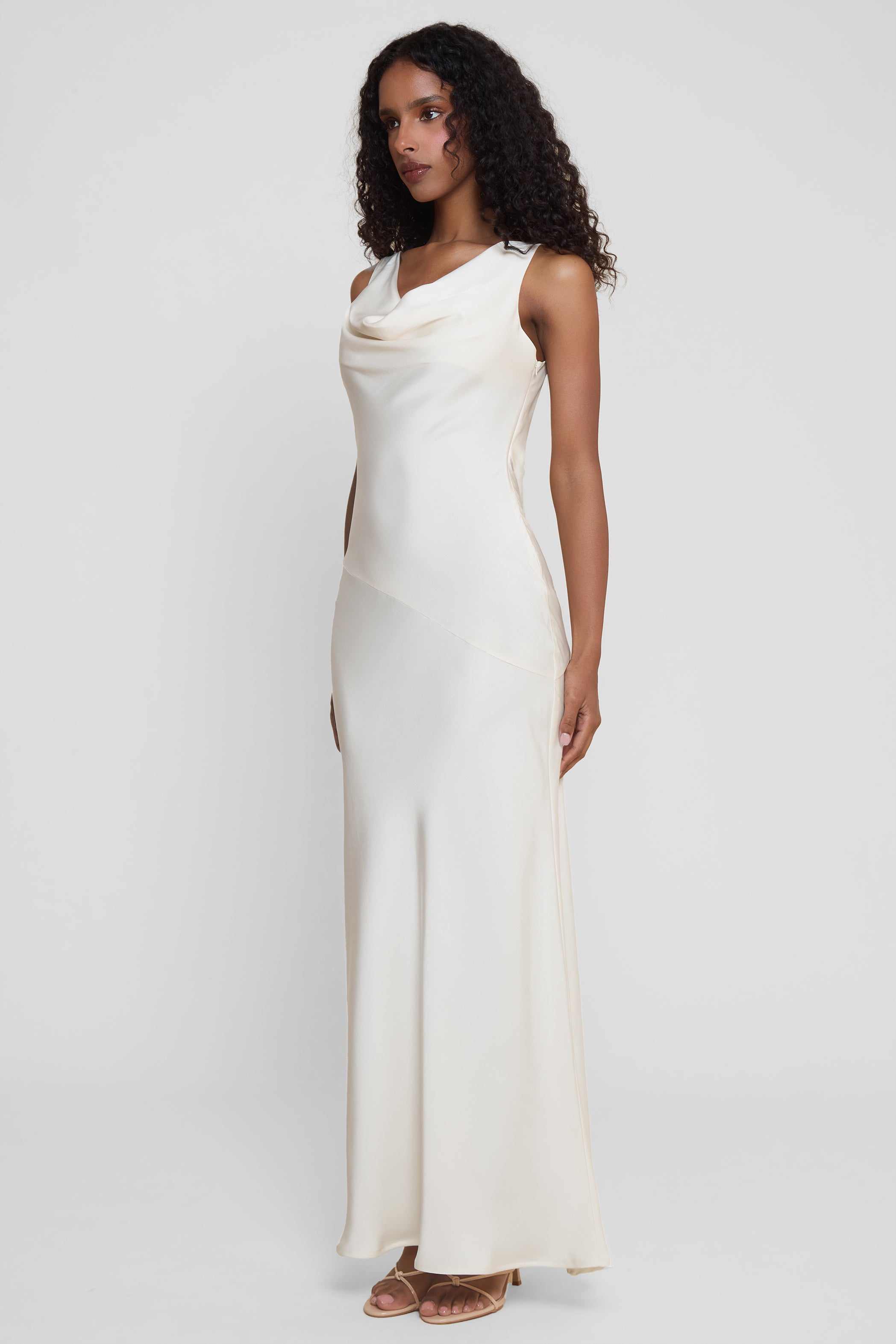 Model wearing Dove Drape Satin Gown in Ivory, front view.