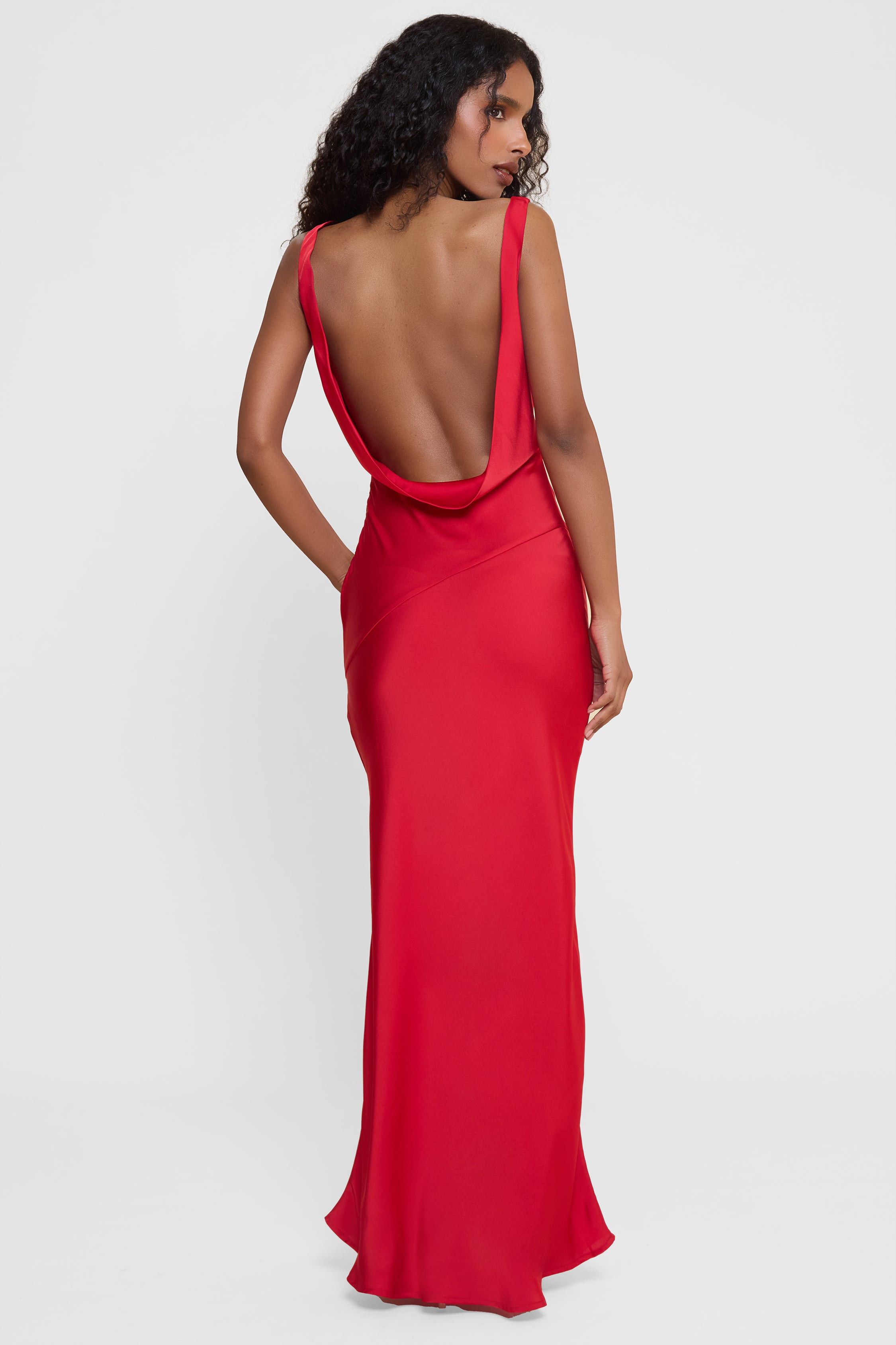 Model wearing Dove Drape Satin Gown in Red, back view.