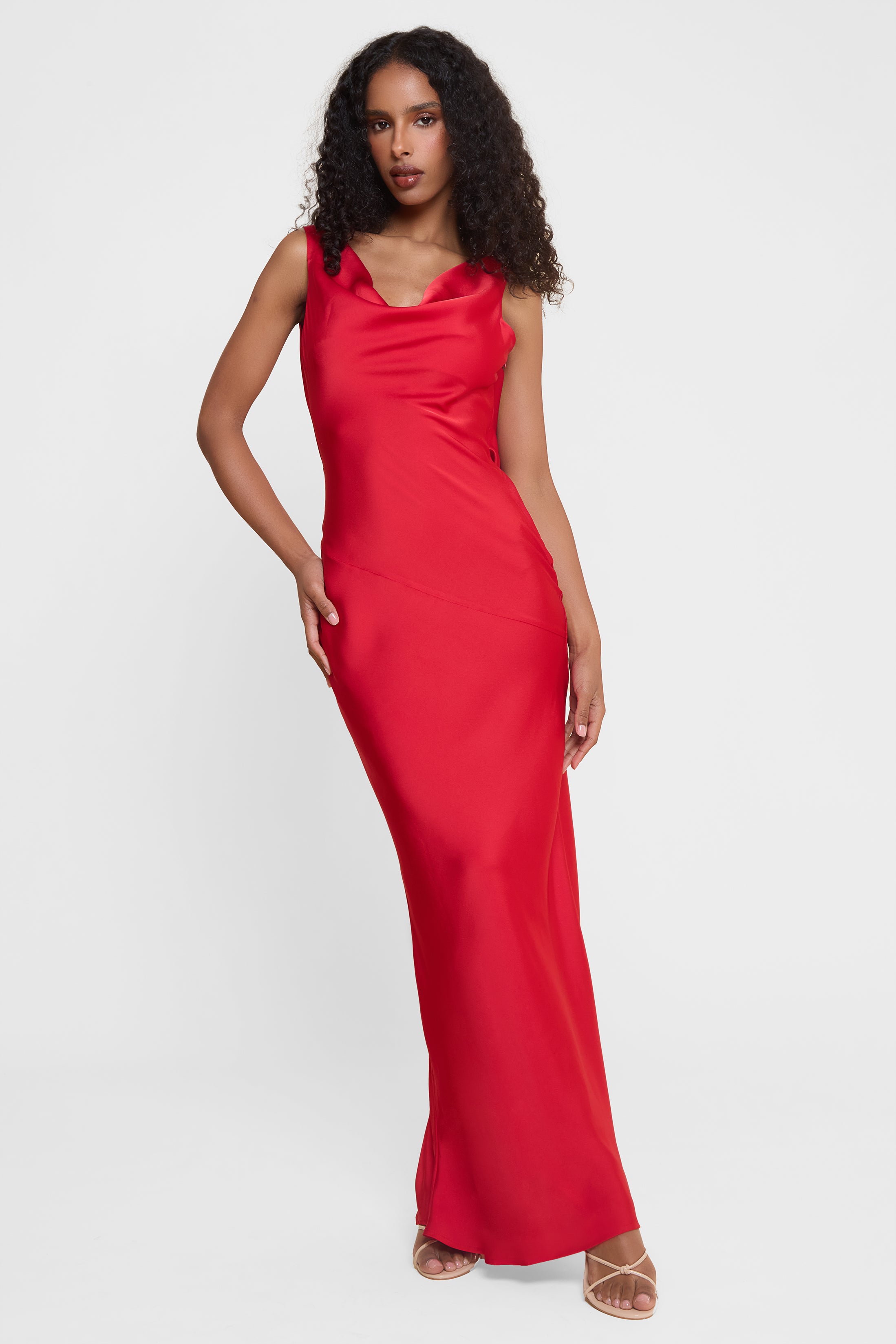 Model wearing Dove Drape Satin Gown in Red, front view.