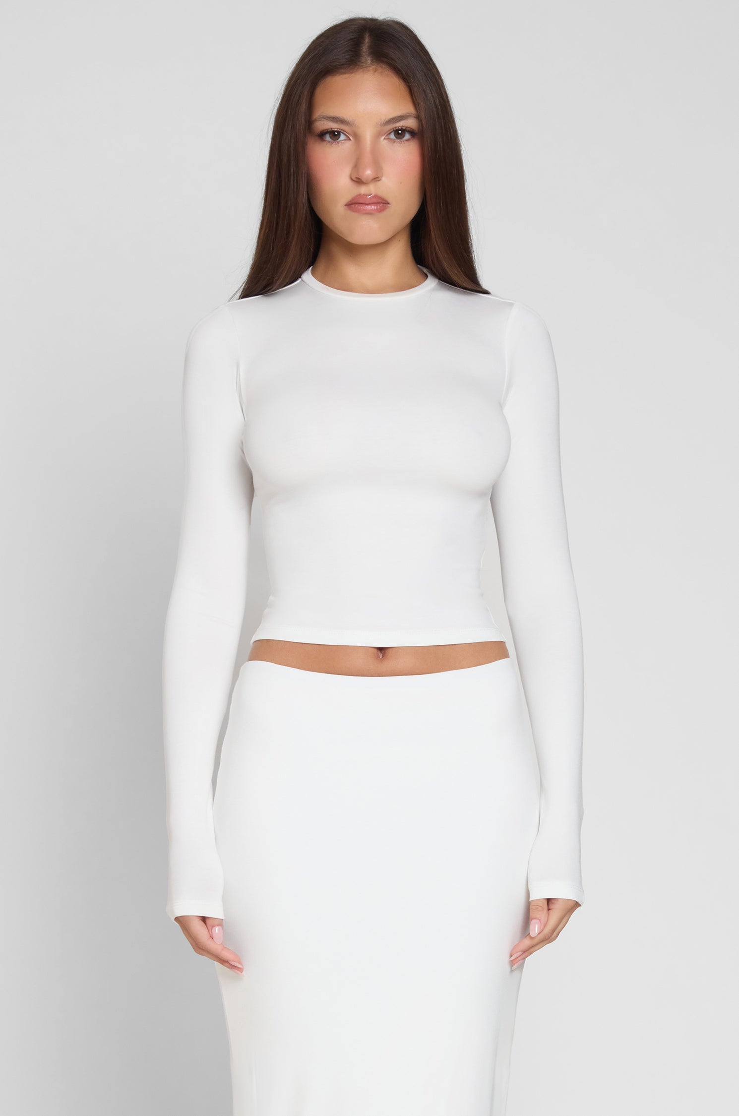 Model is wearing Everyday Jersey Long Sleeve Top in White, front view.
