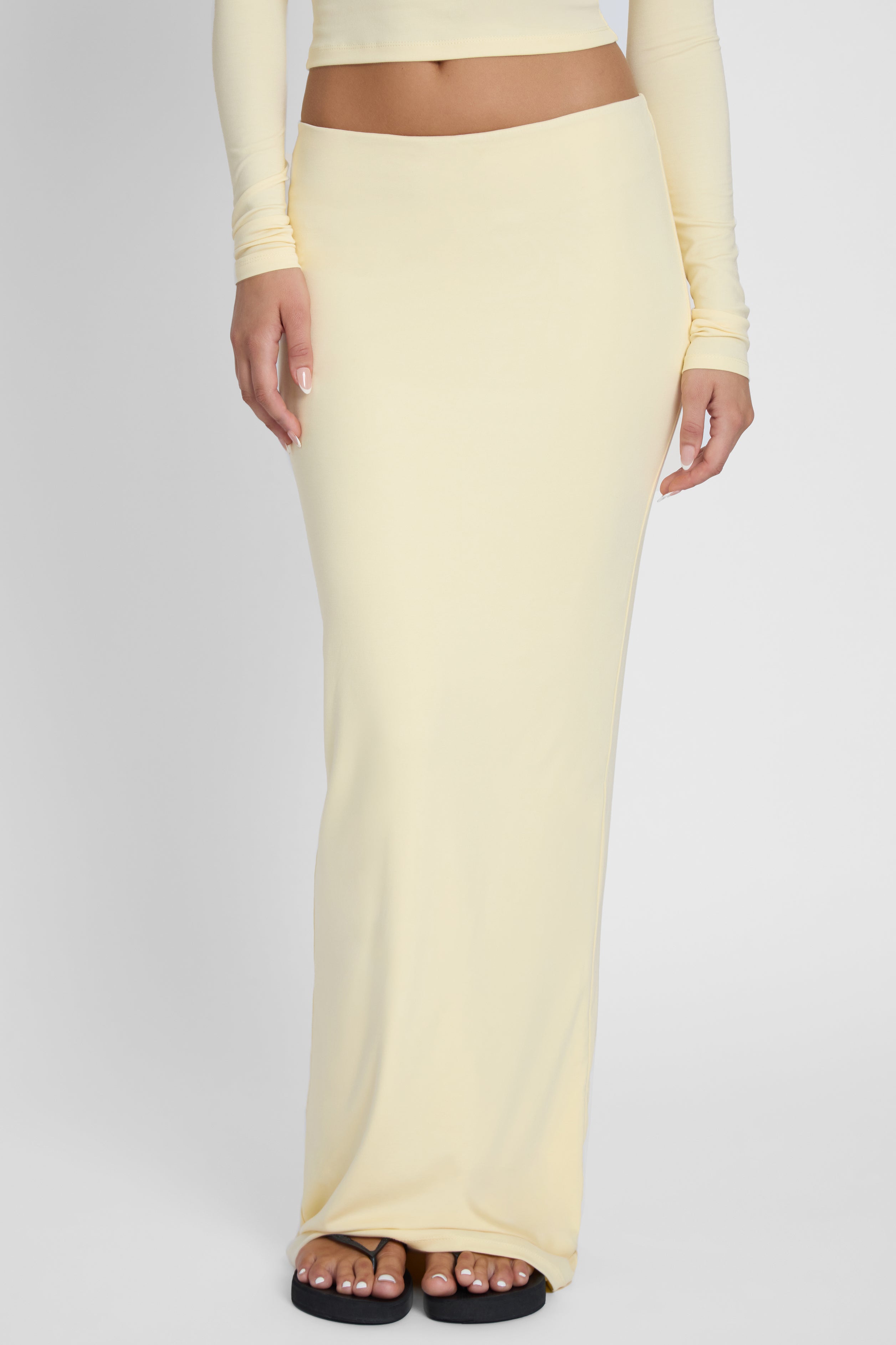 Model is wearing Everyday Jersey Maxi Skirt Yellow, front view.