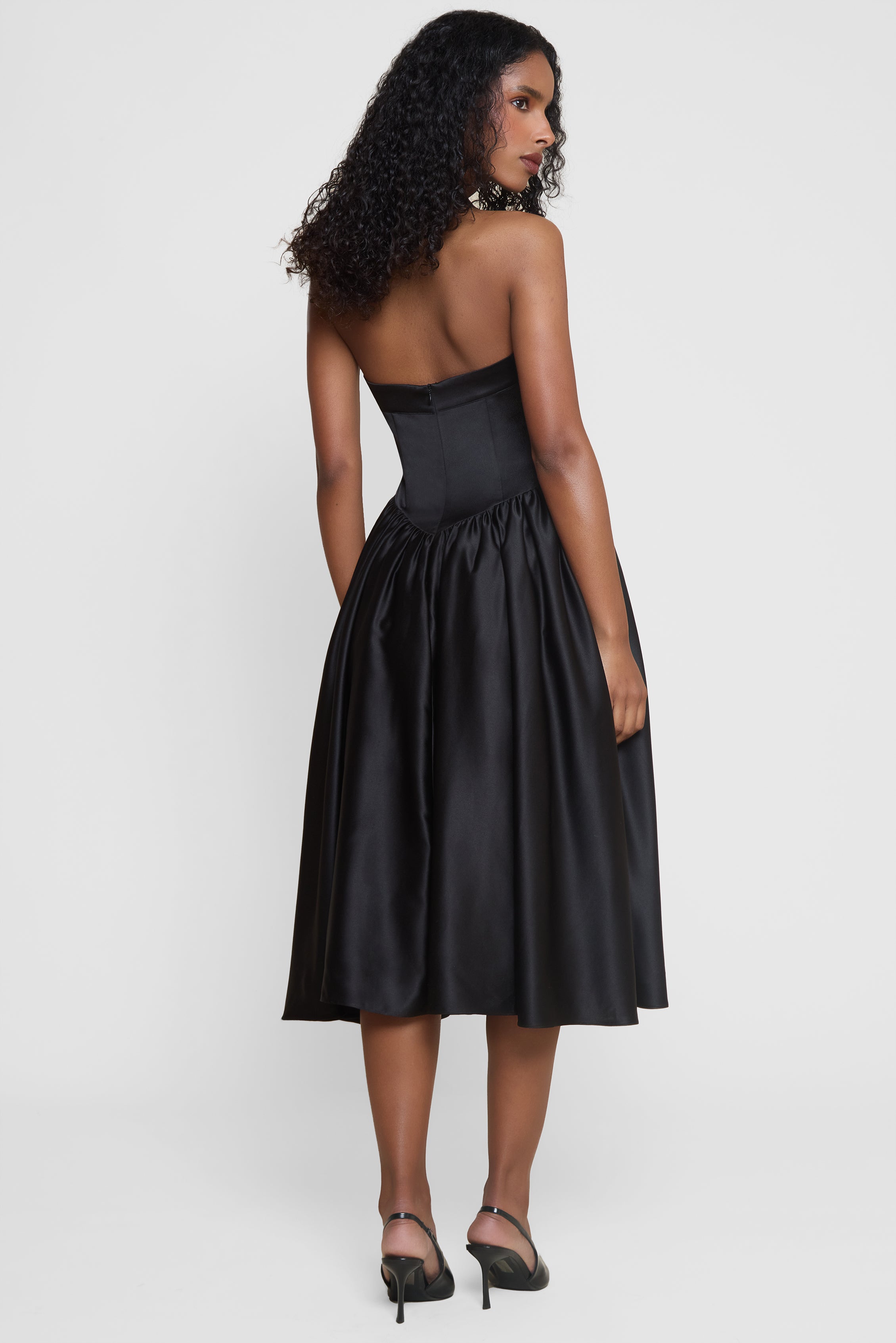 Model wearing Hart Halter Corset Midi Dress in Black, back view