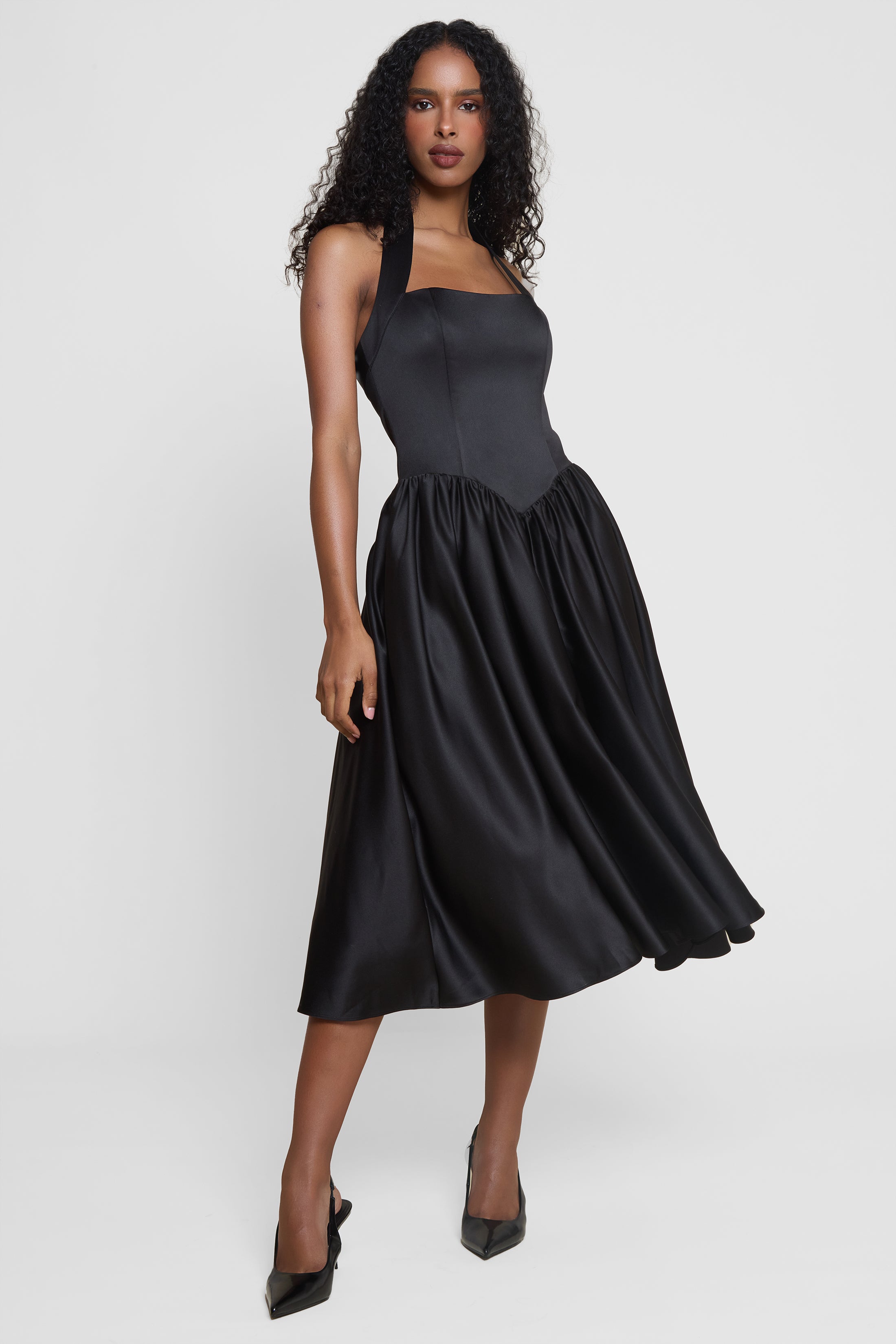 Model wearing Hart Halter Corset Midi Dress in Black, front view