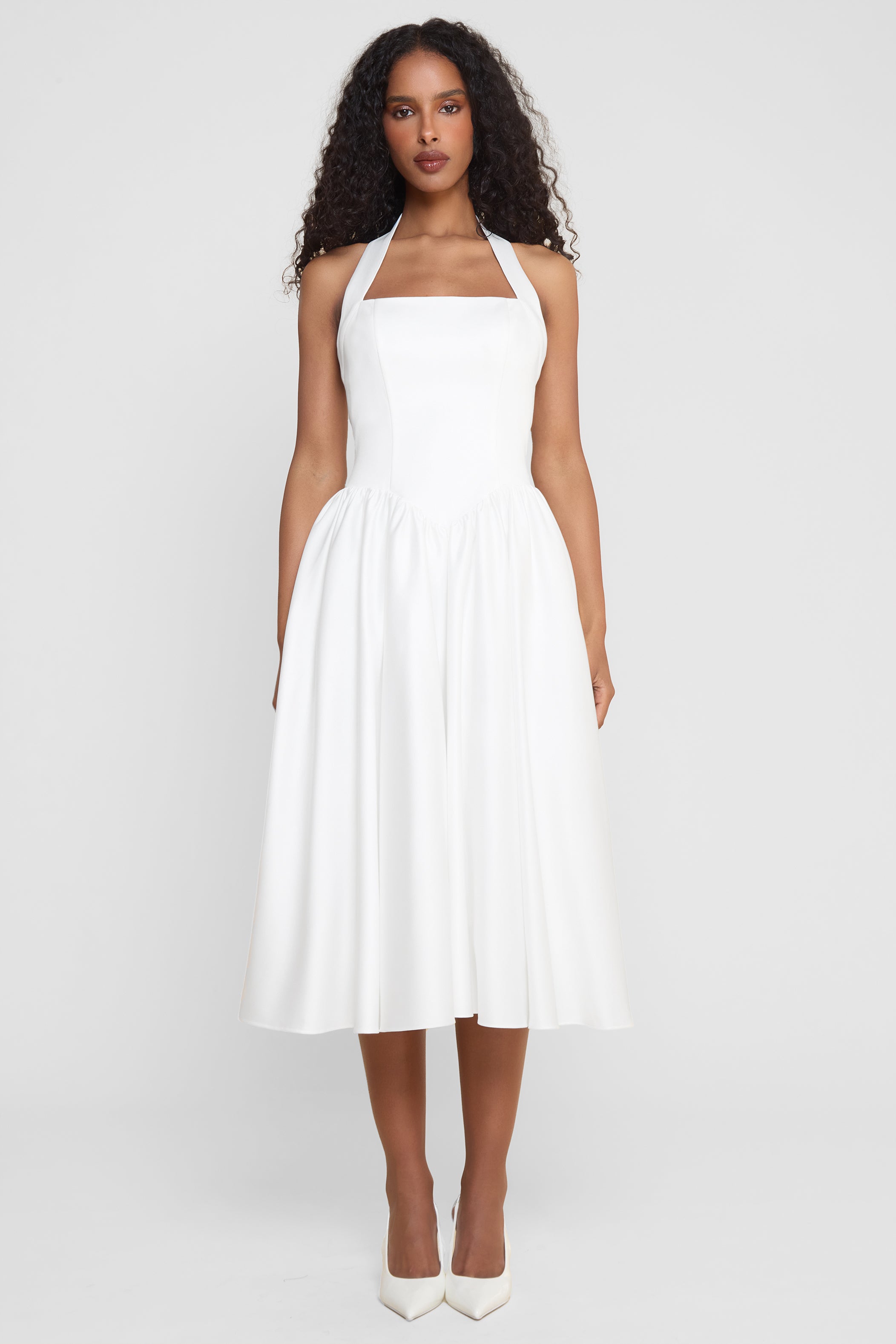 Model wearing Hart Halter Corset Midi Dress in White, front view