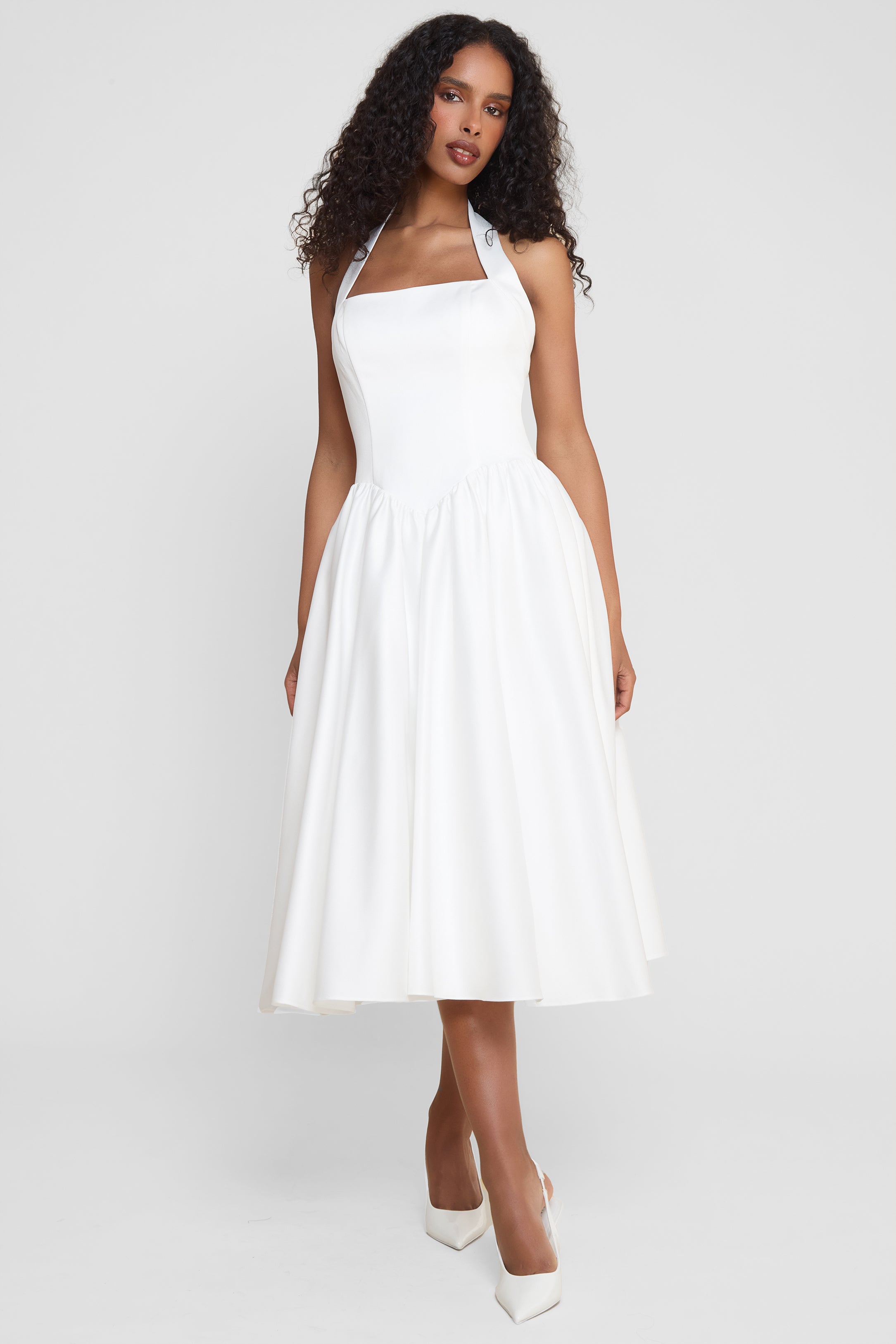 Model wearing Hart Halter Corset Midi Dress in White, front view