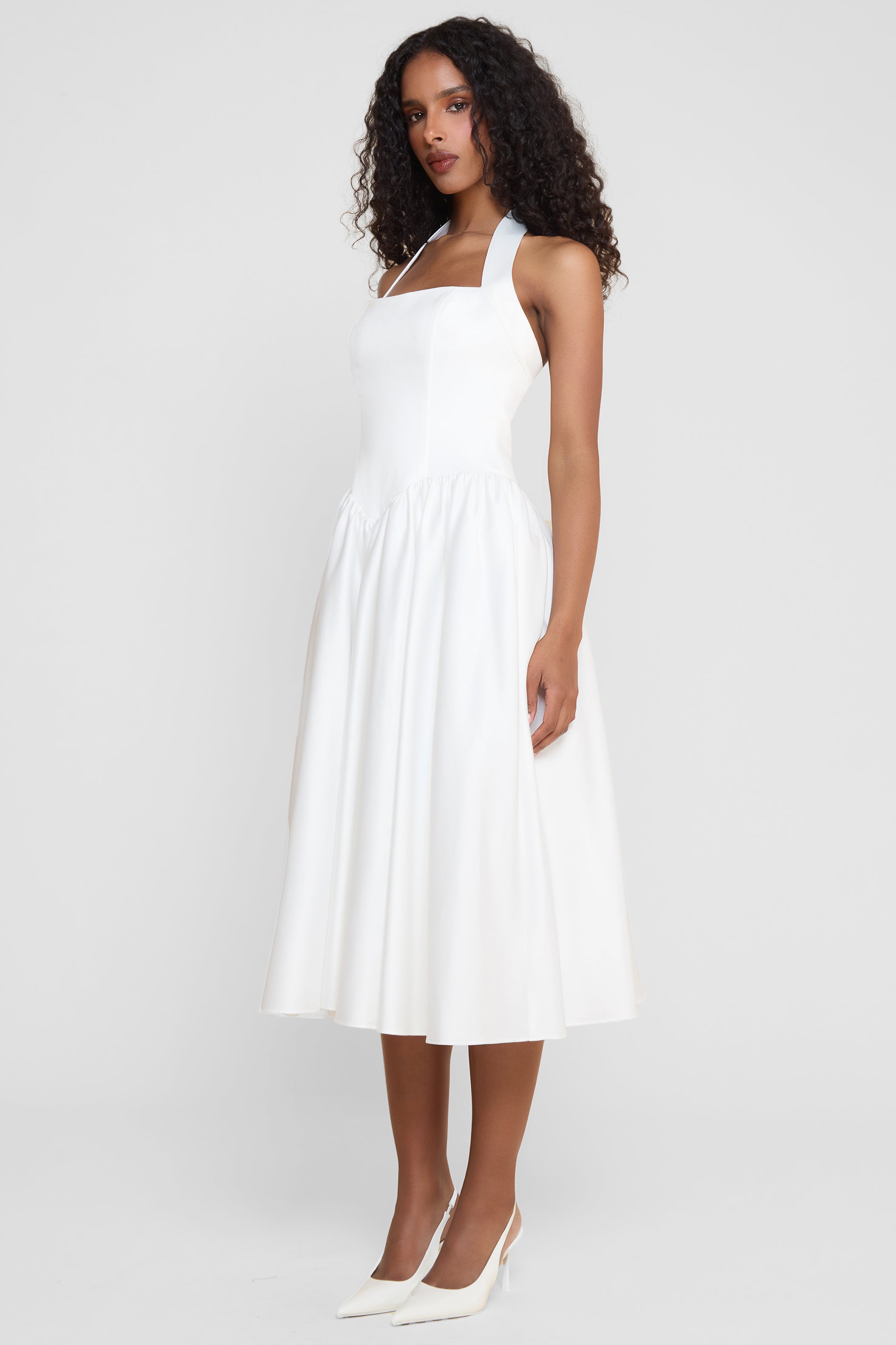 Model wearing Hart Halter Corset Midi Dress in White, side view