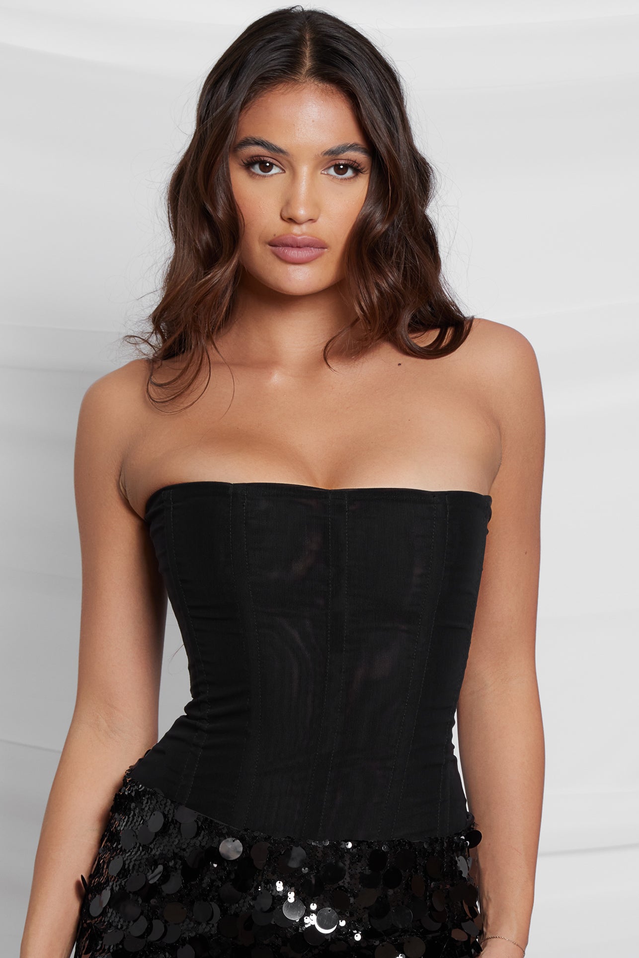 Model wearing Muse Corset in Black, front view.