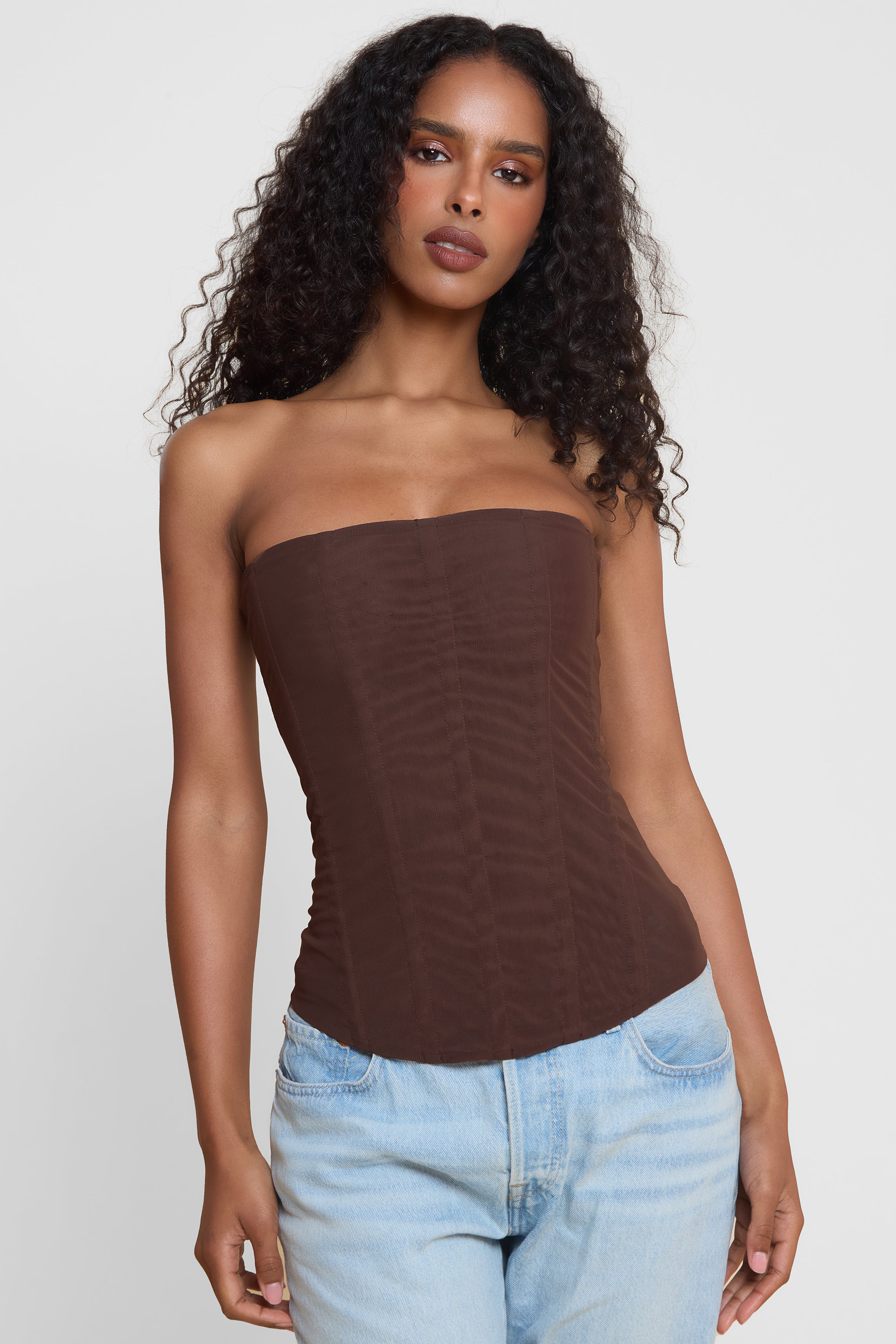 Model wearing Muse Mesh Corset Top in Chocolate Brown, front view.