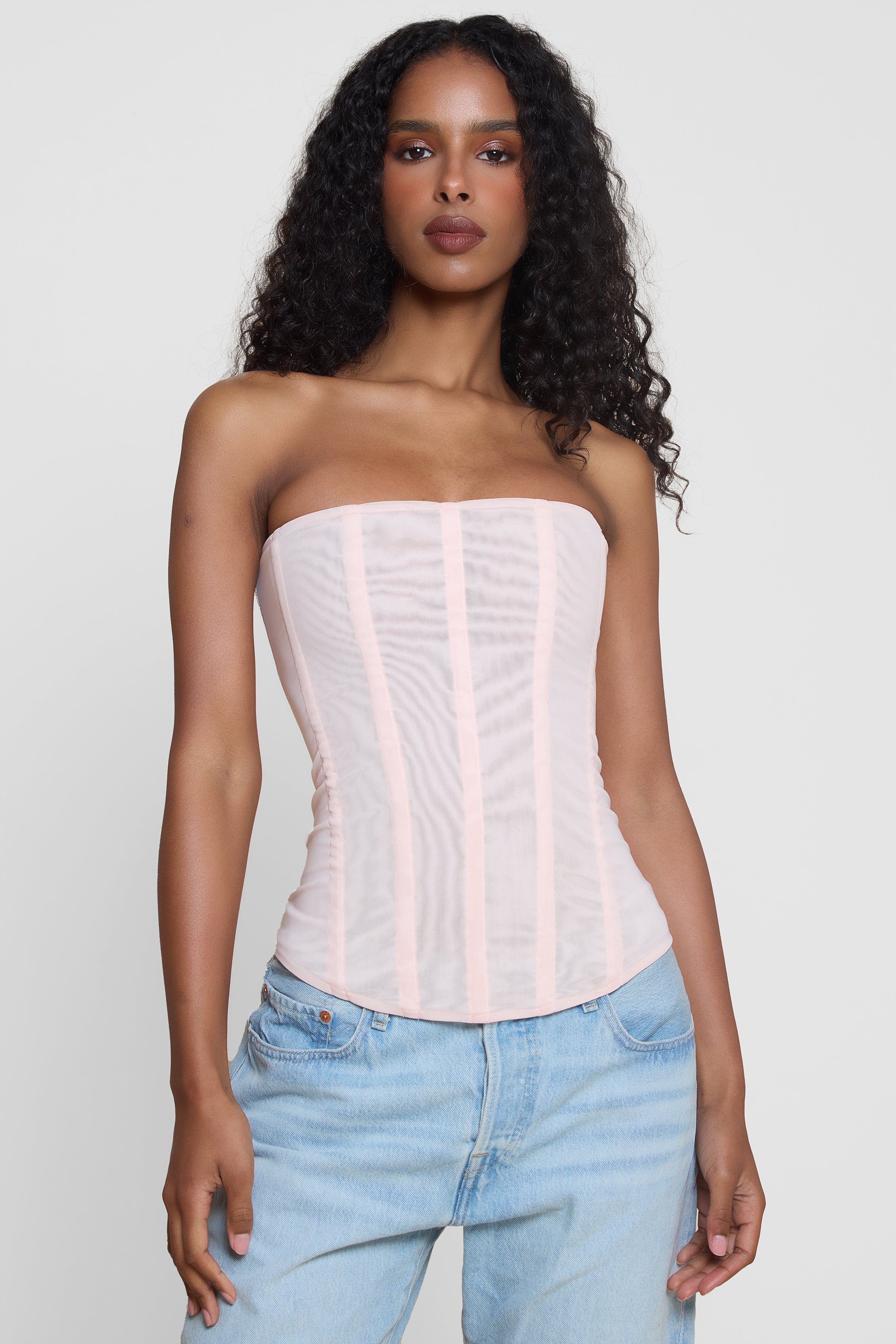 Model wearing Muse Mesh Corset Top in Pink, front view.