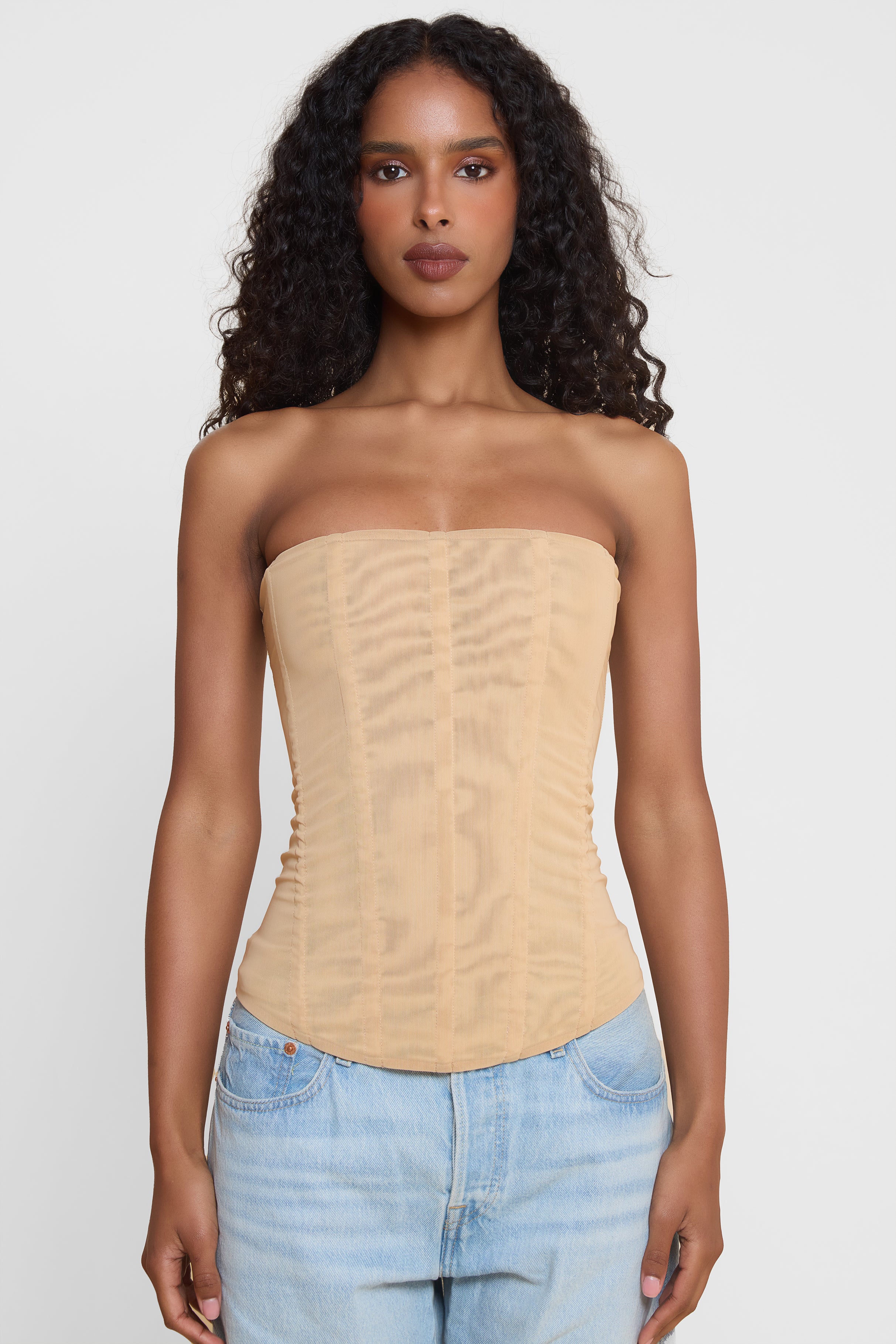 Model wearing Muse Mesh Corset Top in Tan, front view.