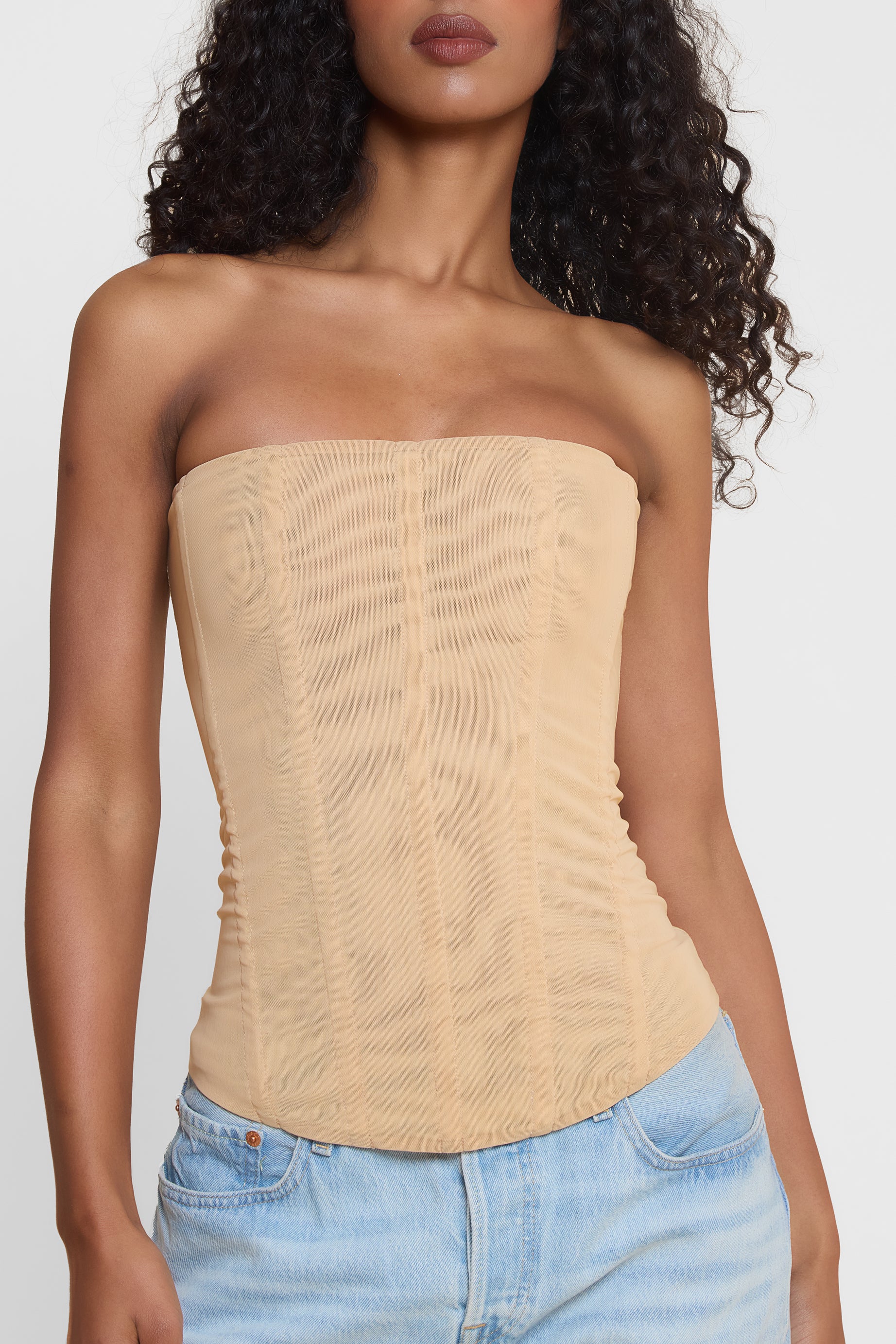 Model wearing Muse Mesh Corset Top in Tan, front view.