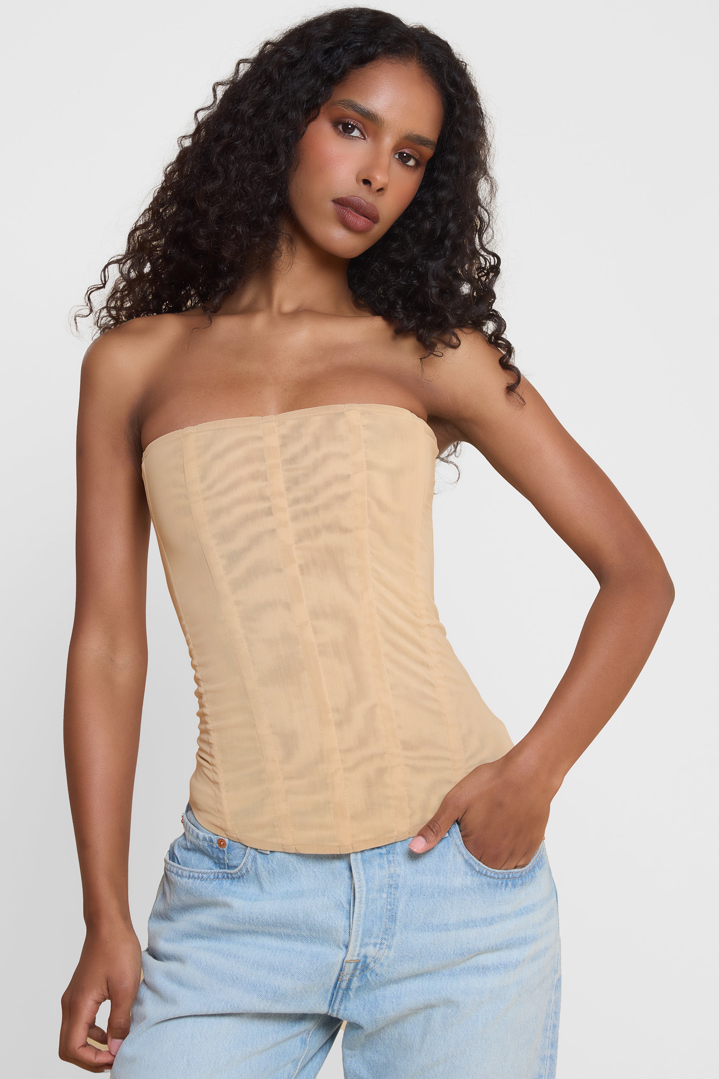 Model wearing Muse Mesh Corset Top in Tan, front view.
