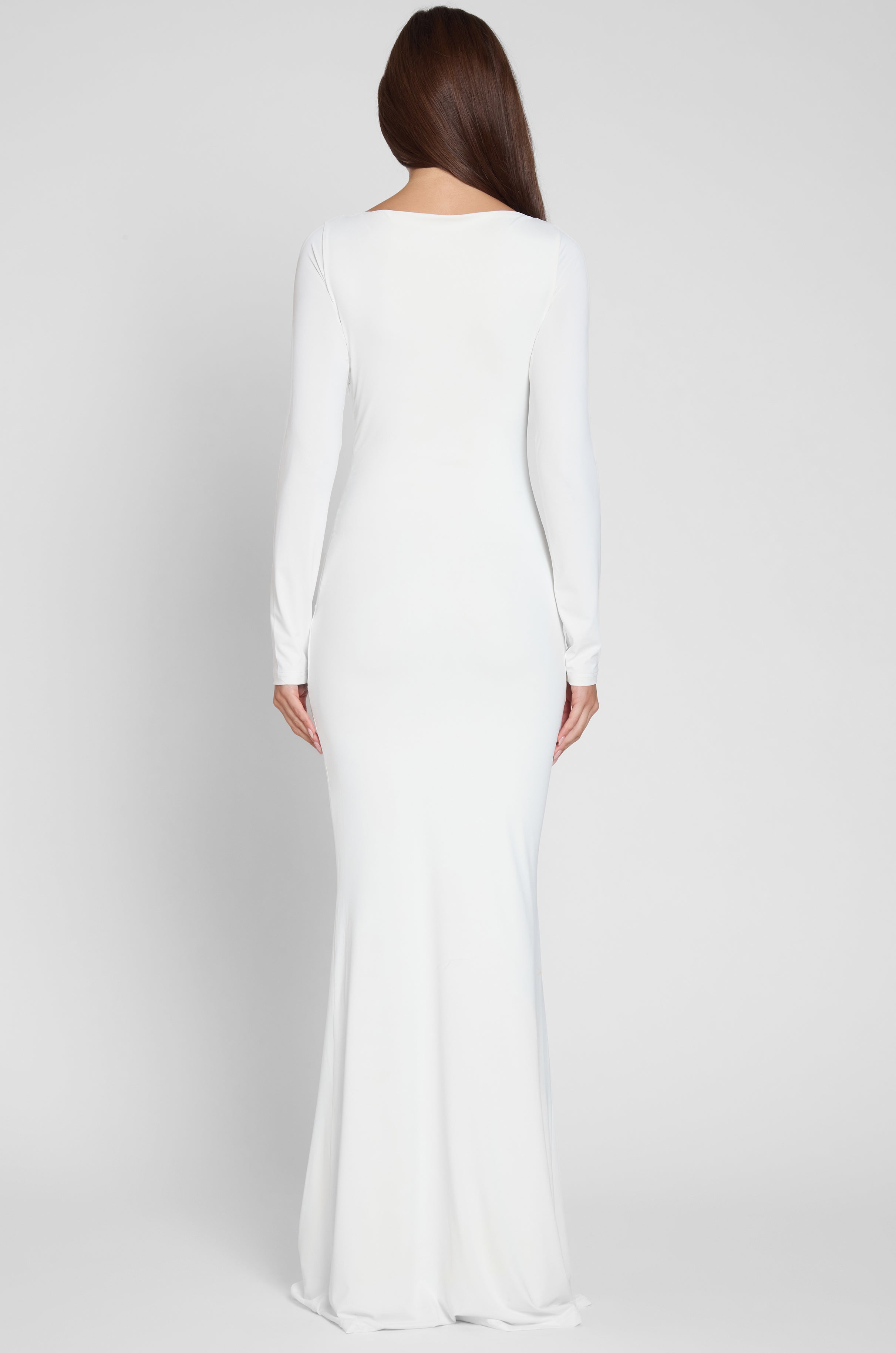 Model is wearing Oasis Knot Maxi Dress in White, back view.