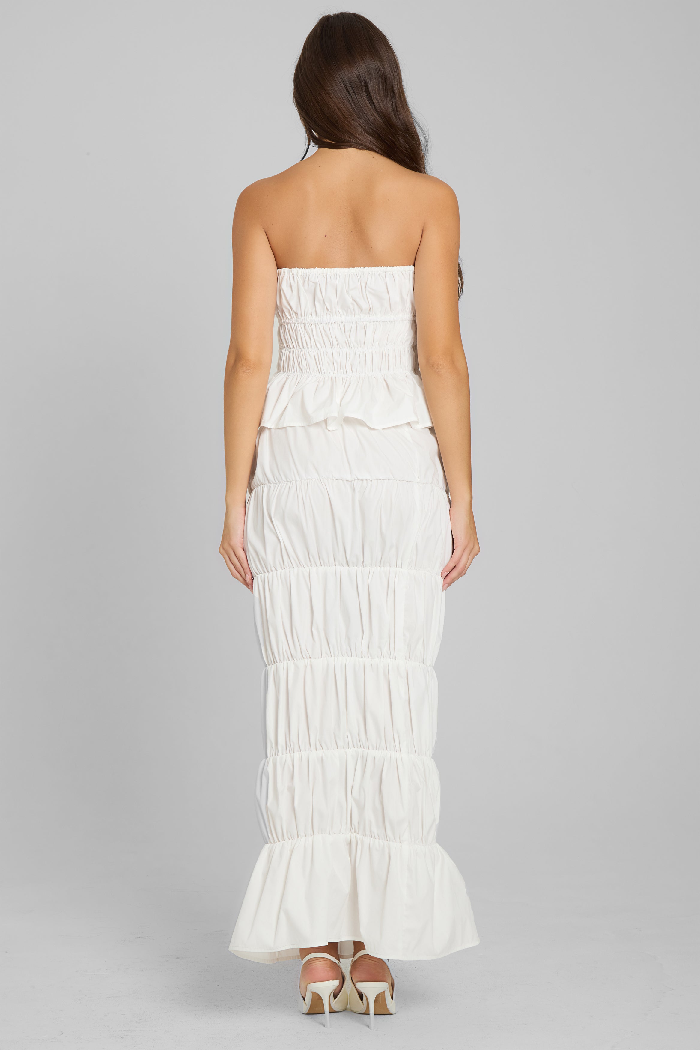 Model wearing Reverie Ruffle Two Piece Set in White, back view.