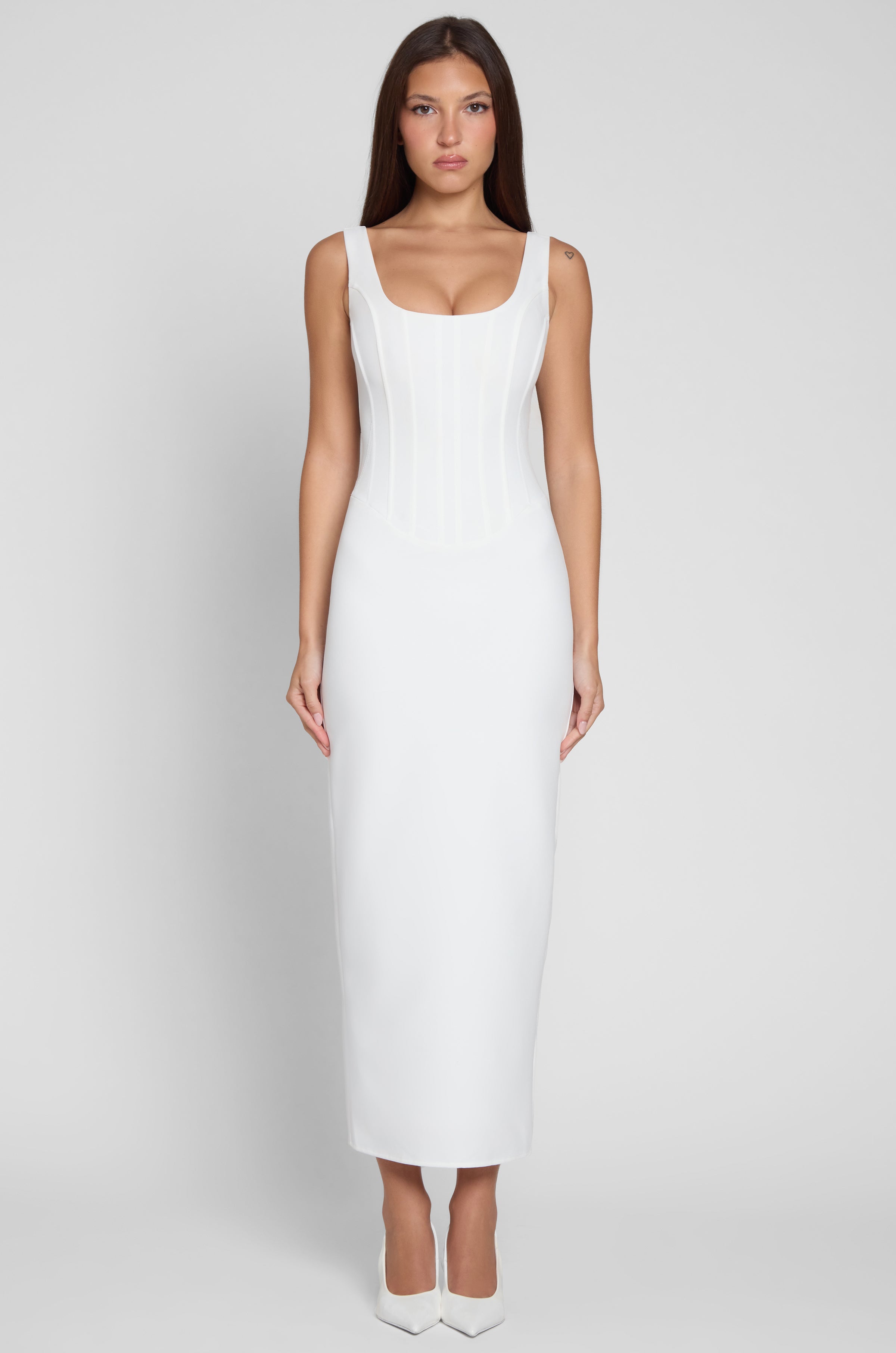 Model wearing Sancia Corset Midi Dress in White, front view.
