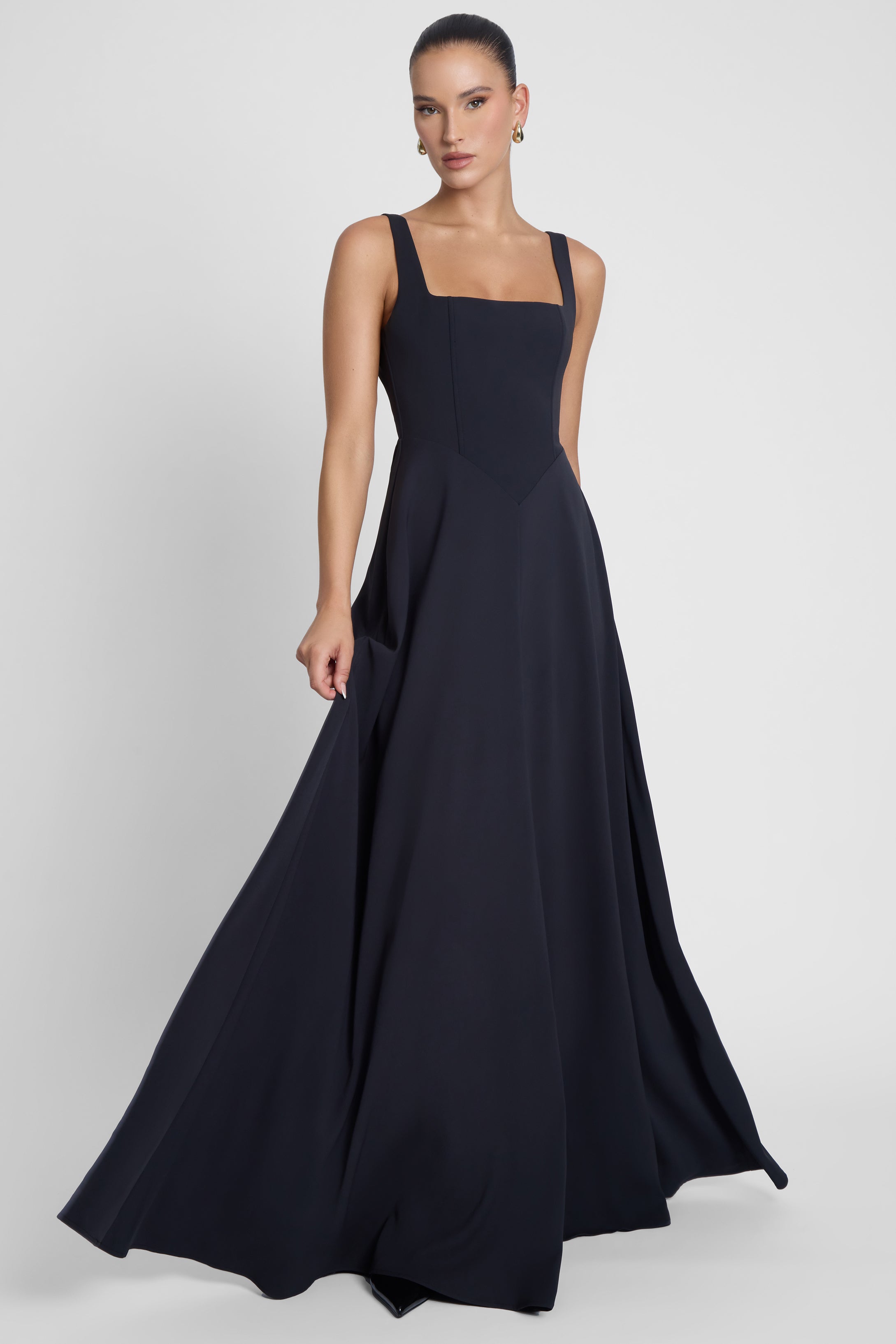 Model is wearing Siren Square Neck Corset Maxi Dress Black, front view.