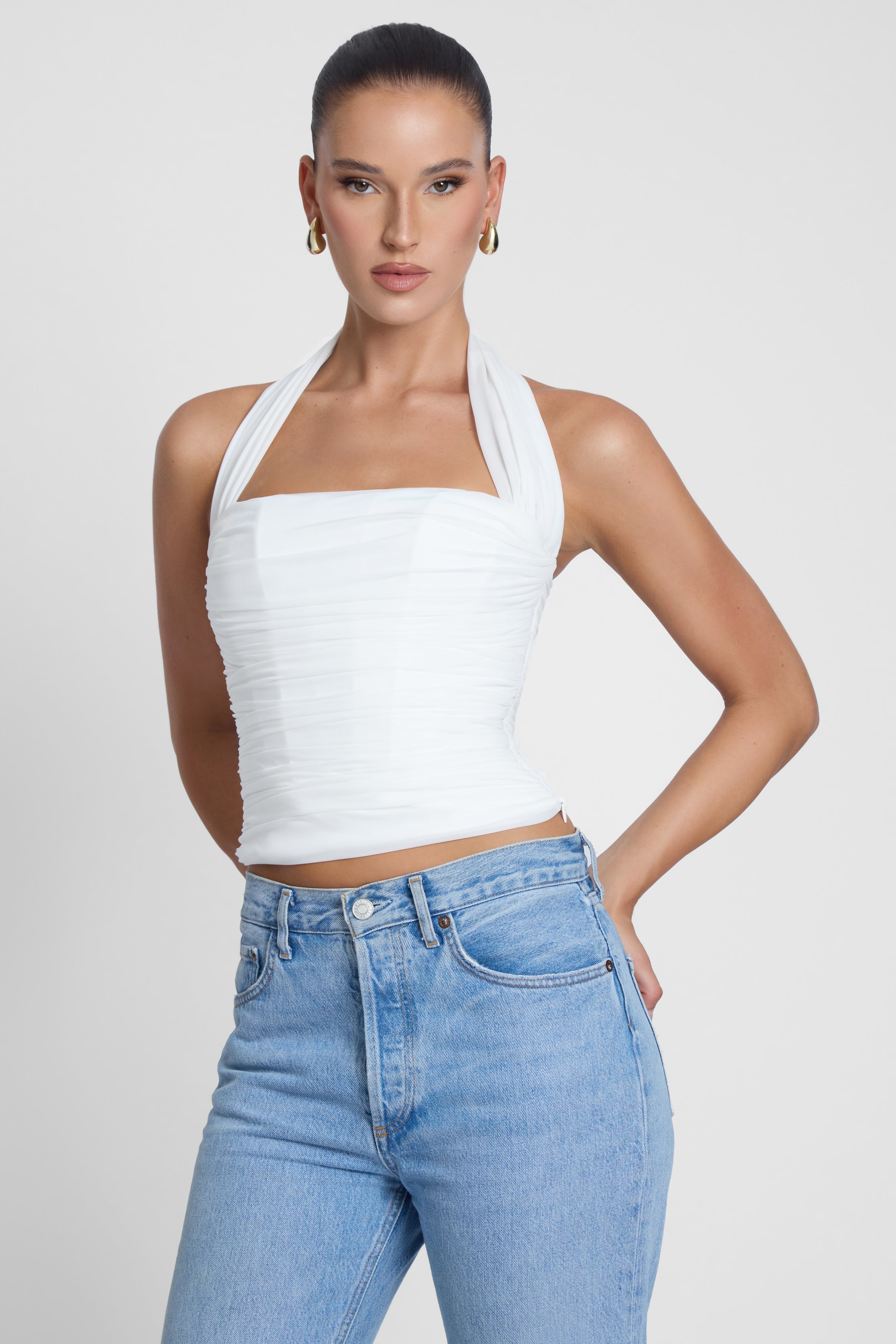 Model is wearing Taormina Halter Corset Top White, front view.