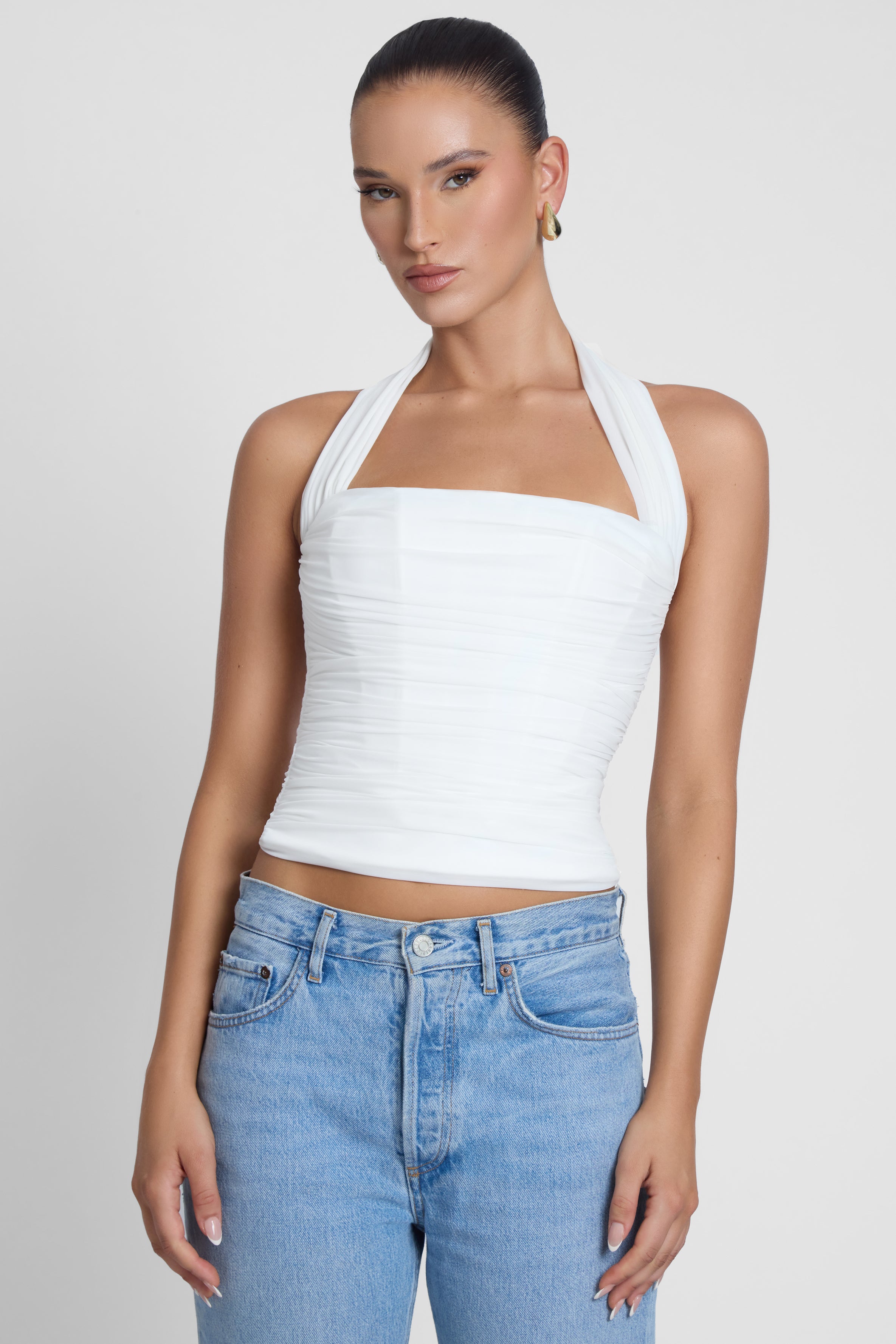 Model is wearing Taormina Halter Corset Top White, front view.