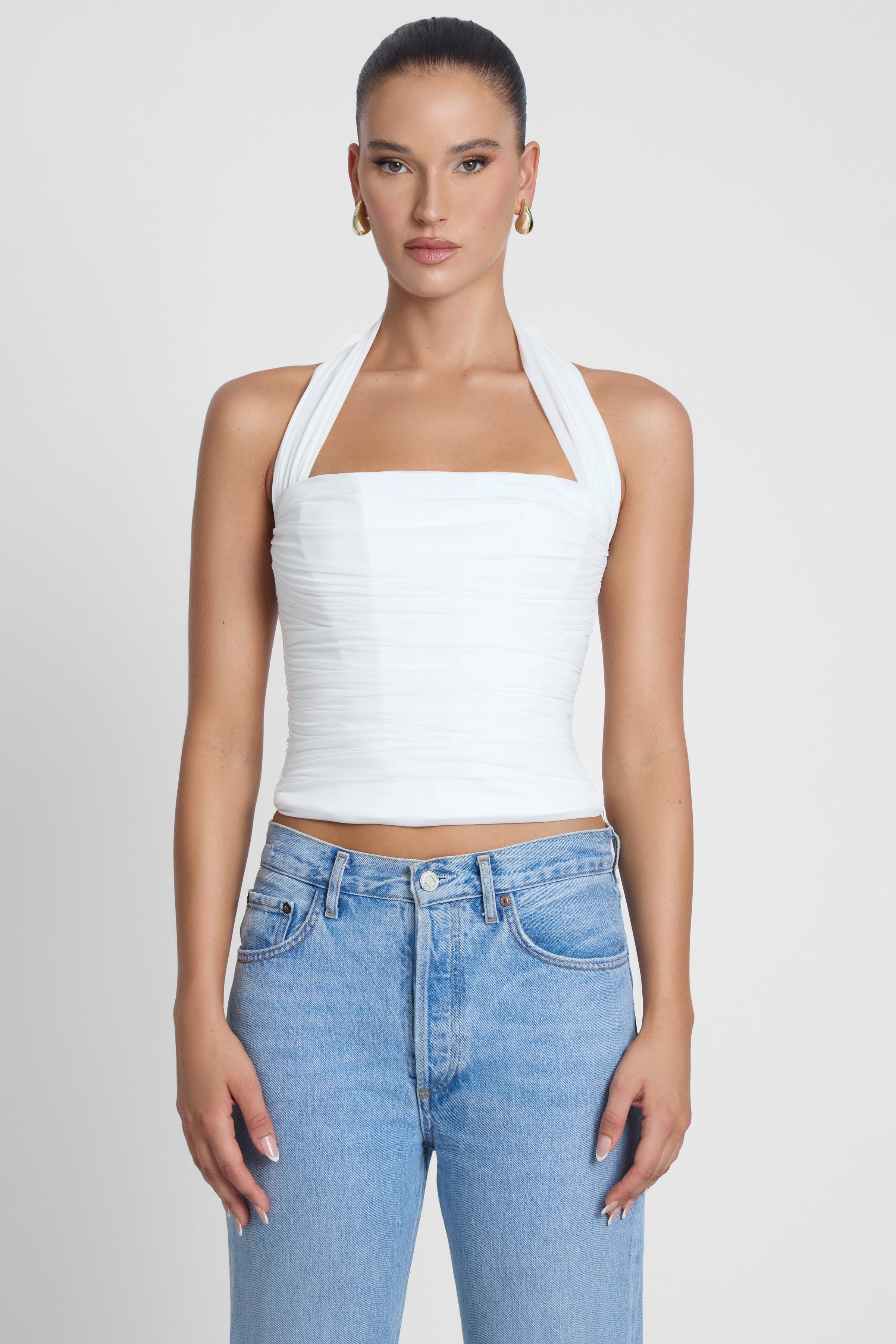 Model is wearing Taormina Halter Corset Top White, front view.