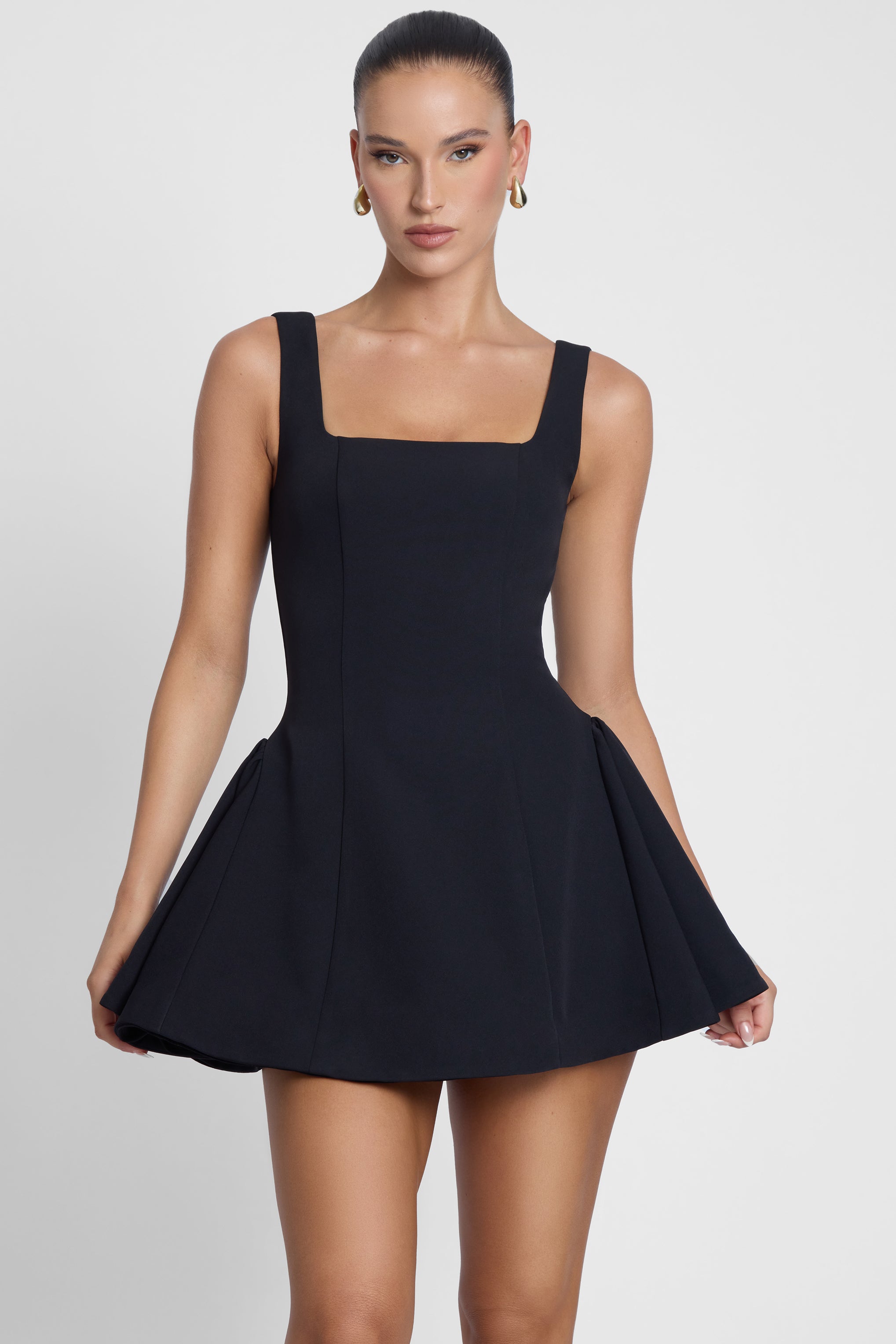 Model is wearing Ysabelle Babydoll Corset Mini Dress Black, front view.