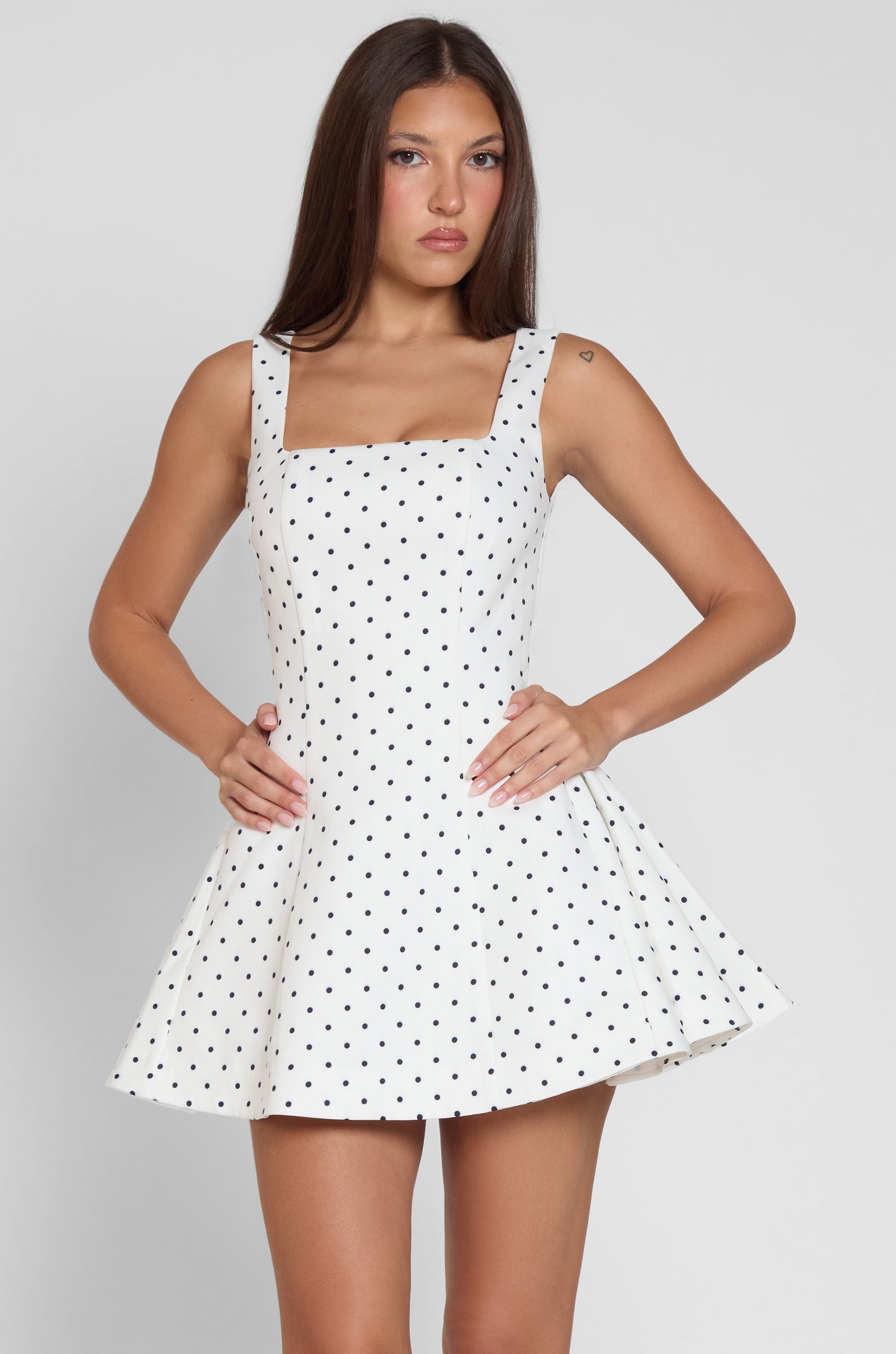 Model is wearing Ysabelle Babydoll Corset Mini Dress in Polka Dot, front view.